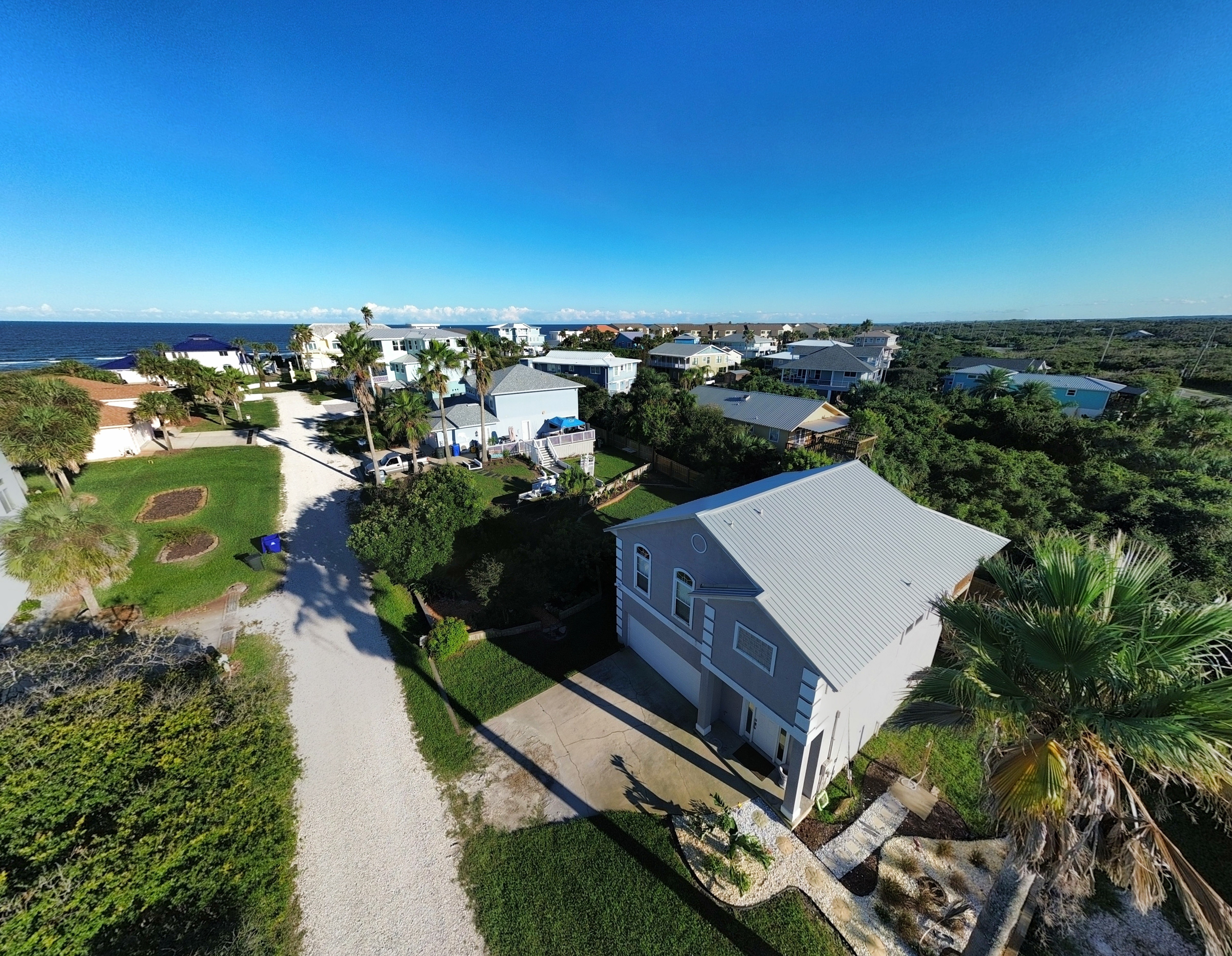 Coastal beach house with palm-lined setting and quick beach access