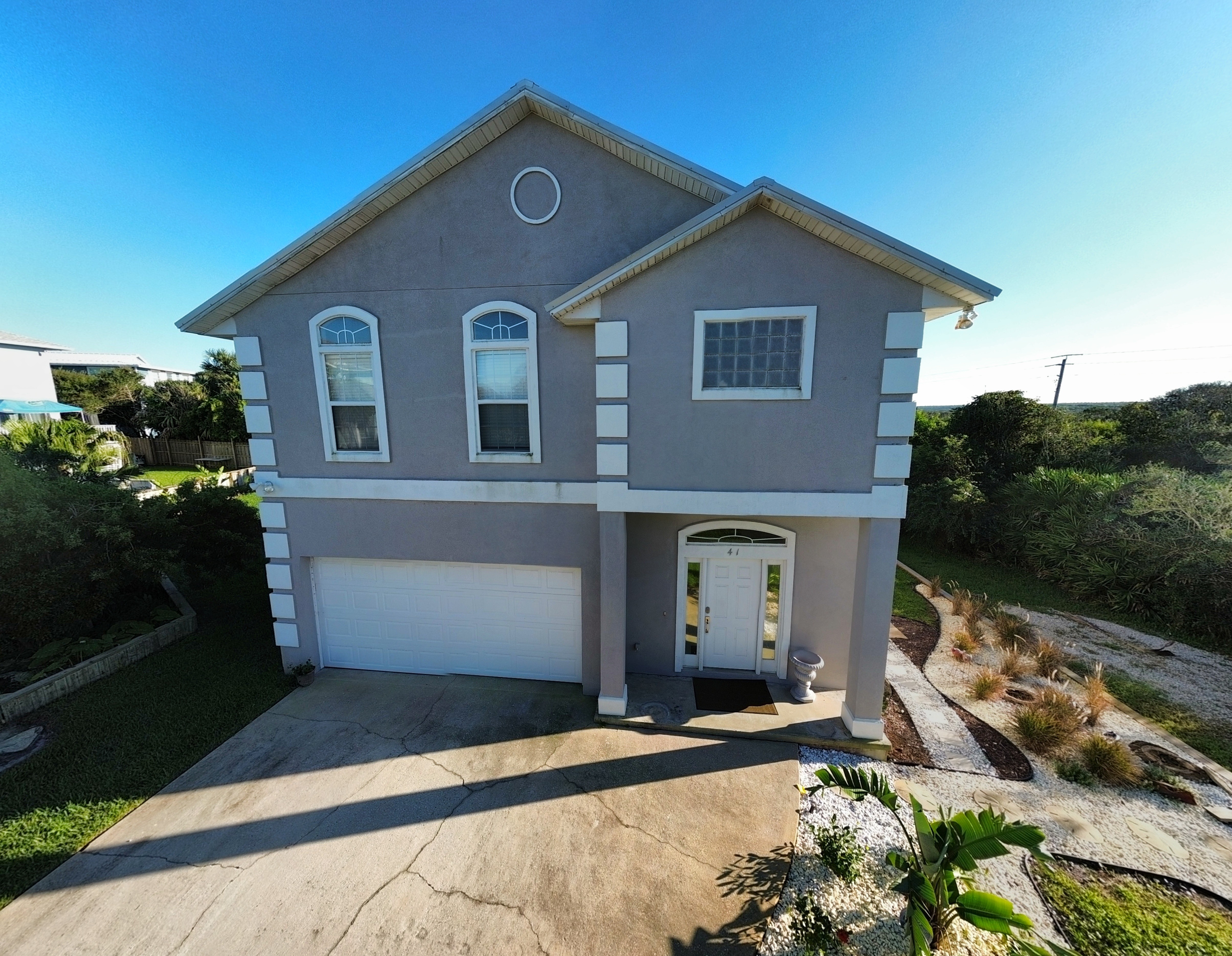 Bright two-story home with garage, private drive, and welcoming entry