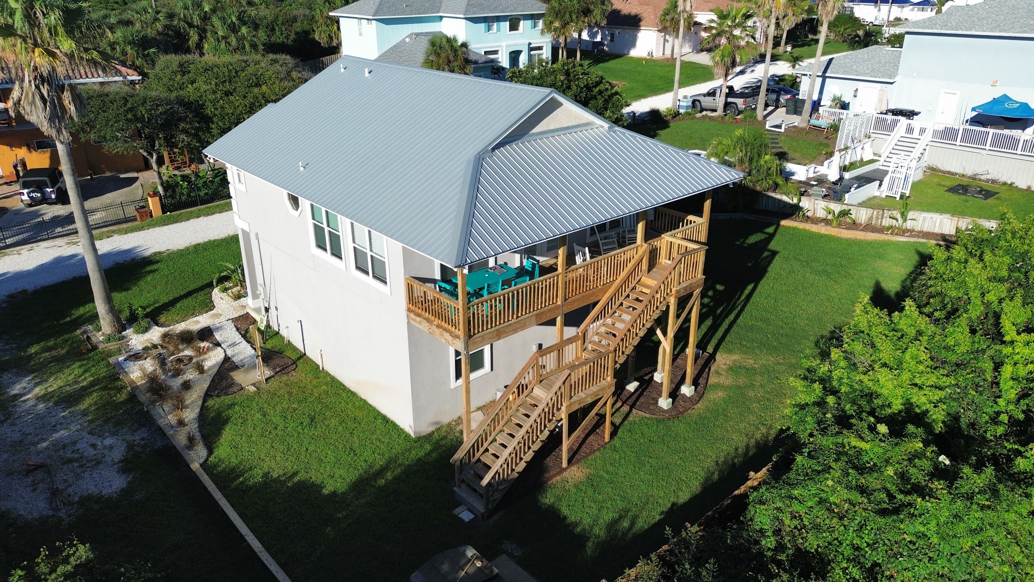 Elevated coastal home with covered deck and spacious yard
