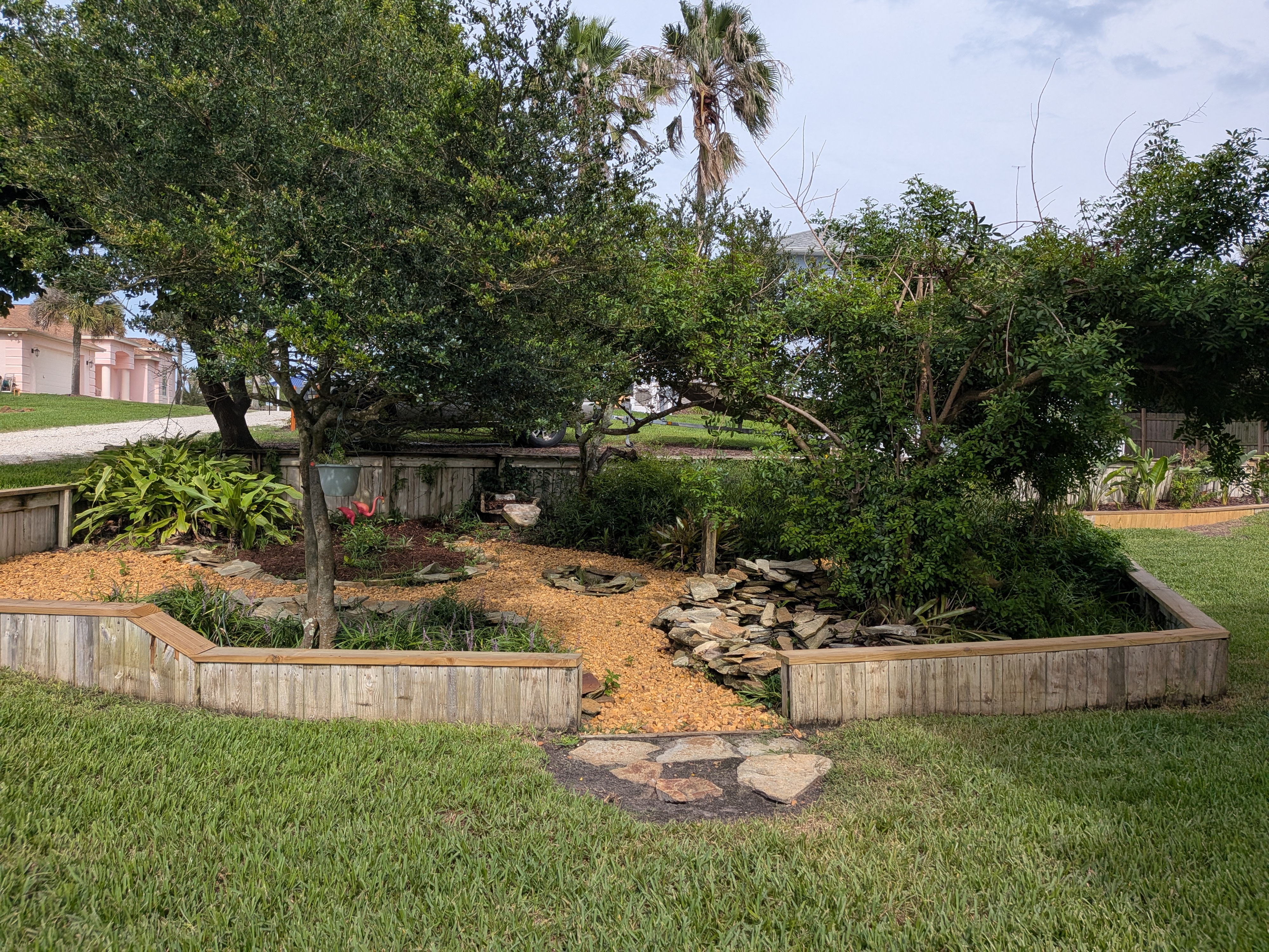 Peaceful landscaped garden with mature trees and charming stone path