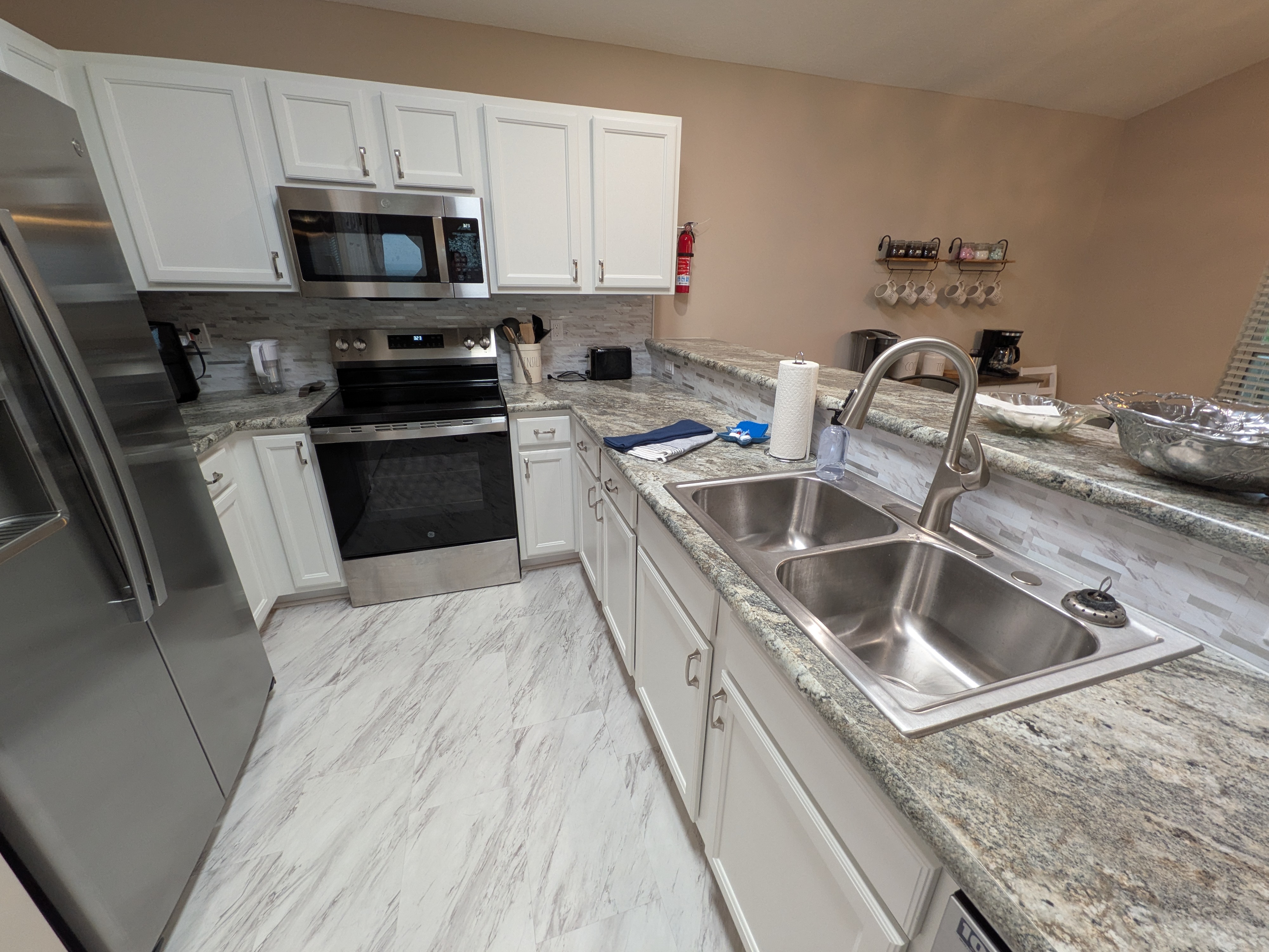Bright updated kitchen with stainless appliances and spacious double sink