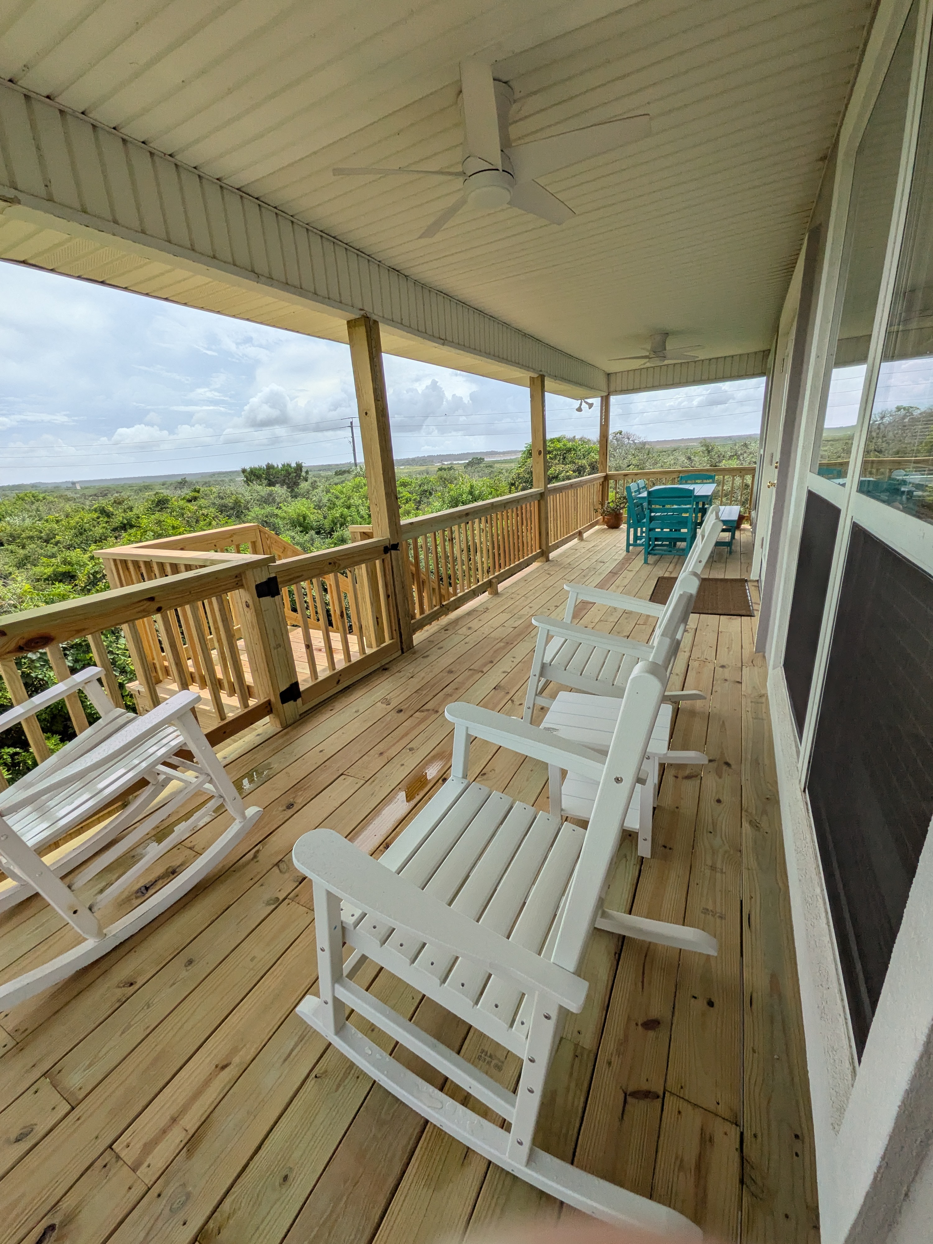 Relax on the covered porch with rocking chairs and scenic water views