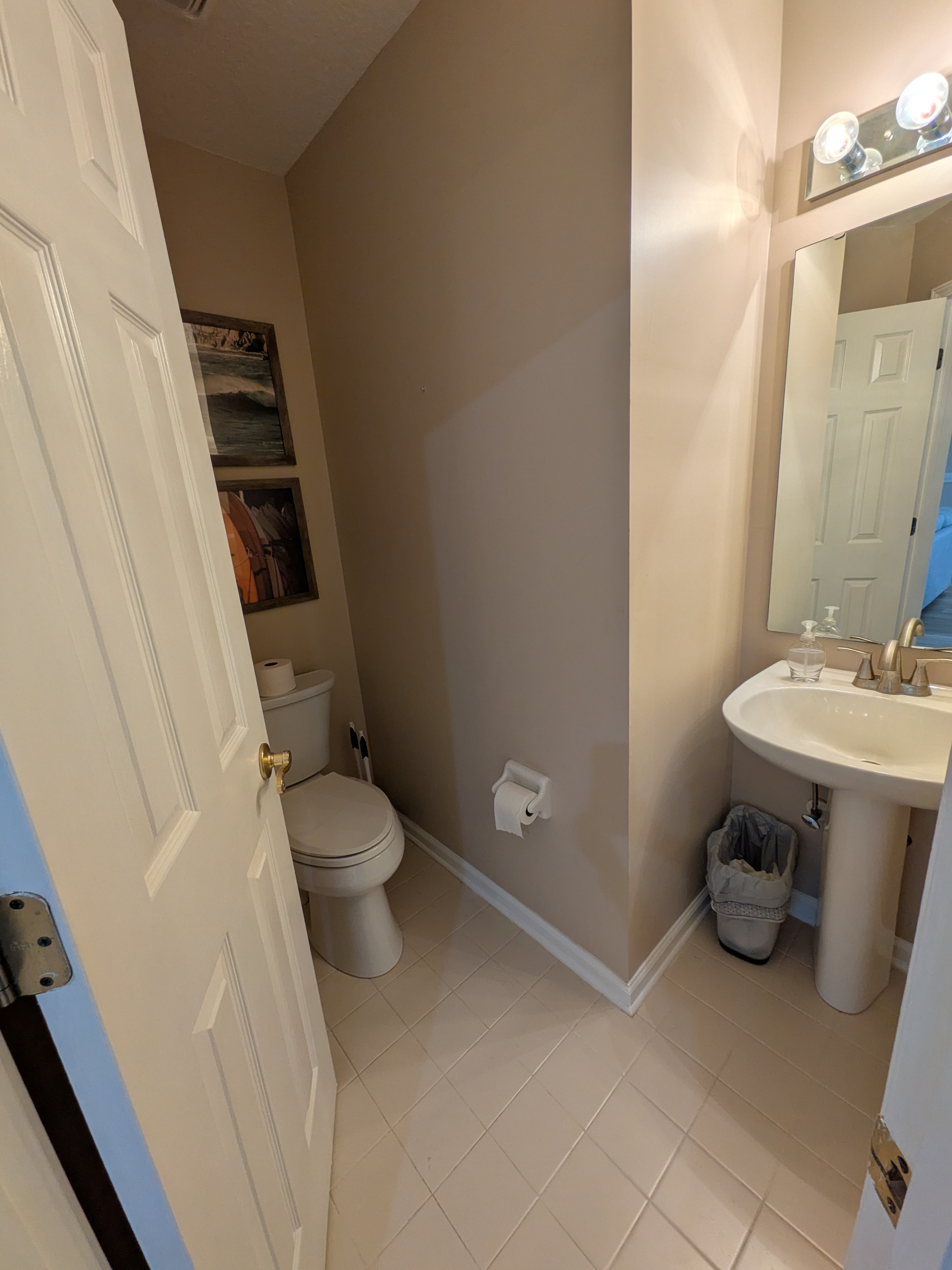 Bright and tidy half bath with pedestal sink and modern fixtures