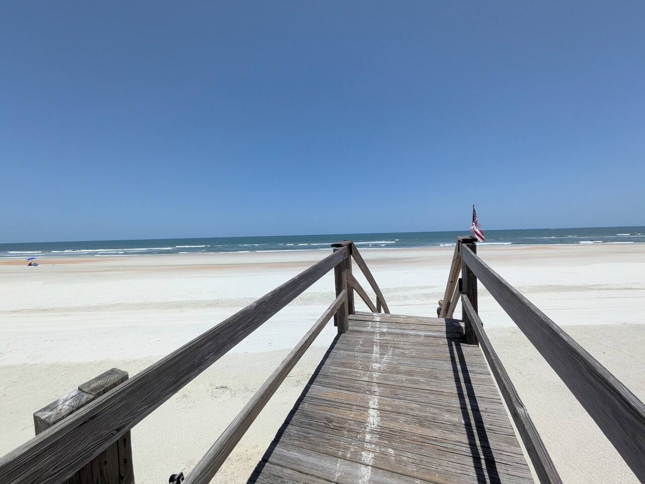 Private boardwalk to a wide, peaceful beachfront escape