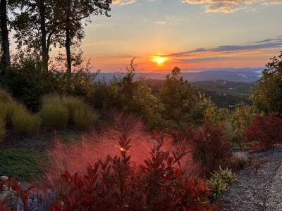 Breathtaking mountain sunset views framed by lush landscaped gardens