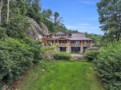 Built right into the granite cliff, the house seems to grow out of the mountain itself, wrapped in covered porches on every level.