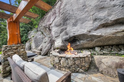 Pull a chair up to the wood-burning stone fire pit, built right into the base of the cliff for late nights under the stars.
