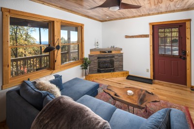 Cozy up in the great room beneath pine ceilings and exposed wood beams, where a stylish sectional invites the whole group to settle in by the stone fireplace.