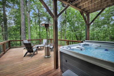 Private forest deck with hot tub, Adirondack seating, and peaceful views
