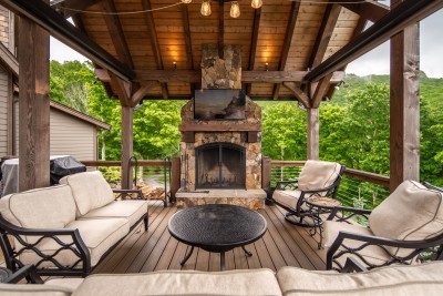 Pull a chair up to the stone outdoor fireplace, turn on the game, and let the evening run long under the timber pavilion and string lights.