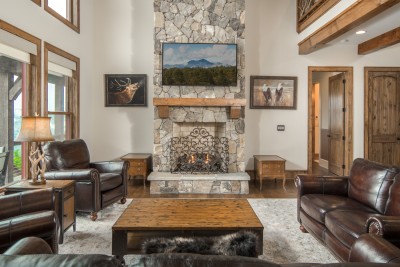 Gas logs behind the wrought-iron screen take the chill off a mountain evening, with the TV mounted above the timber mantel for movie night.