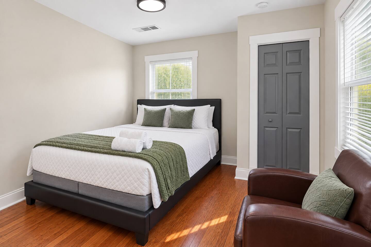Soft green accents and crisp bedding create a calm retreat designed for a relaxing night's sleep.