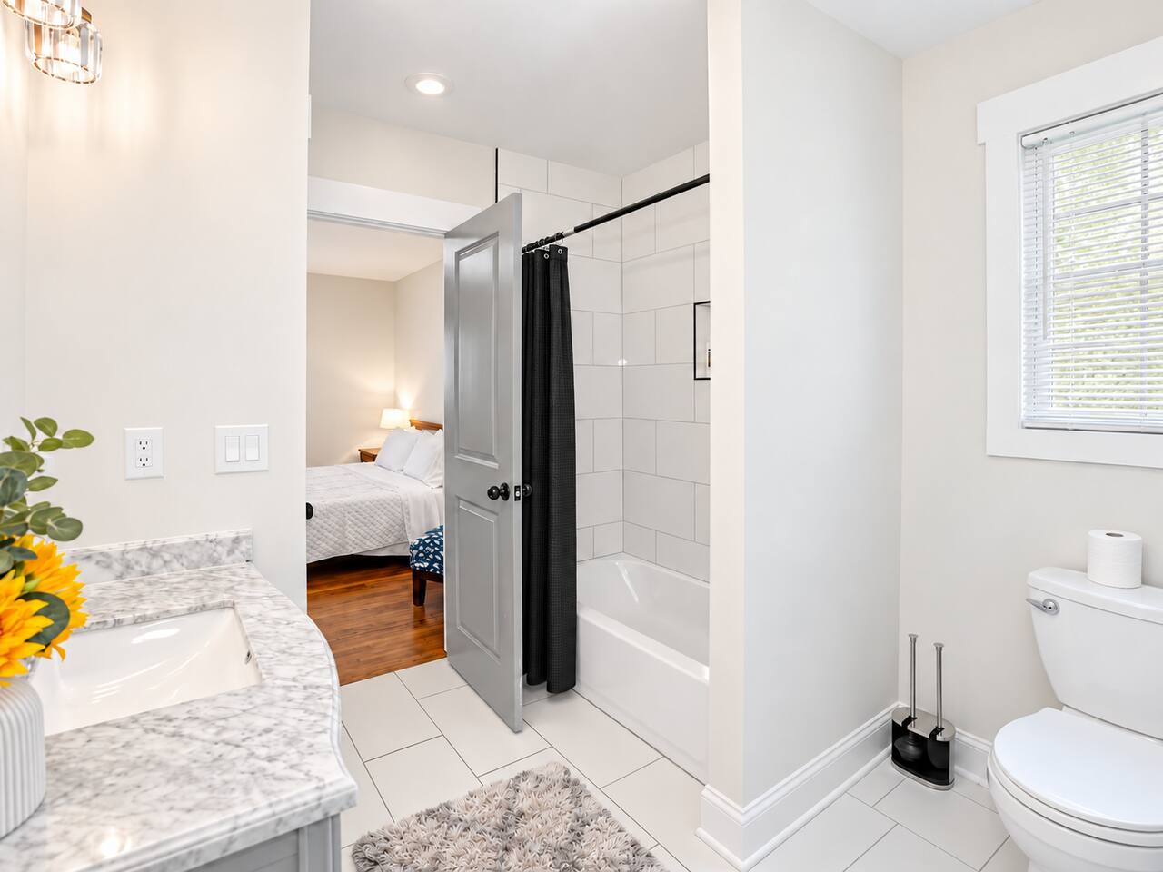 Refresh in this bright bathroom featuring a bathtub, modern tile, and clean contemporary finishes.