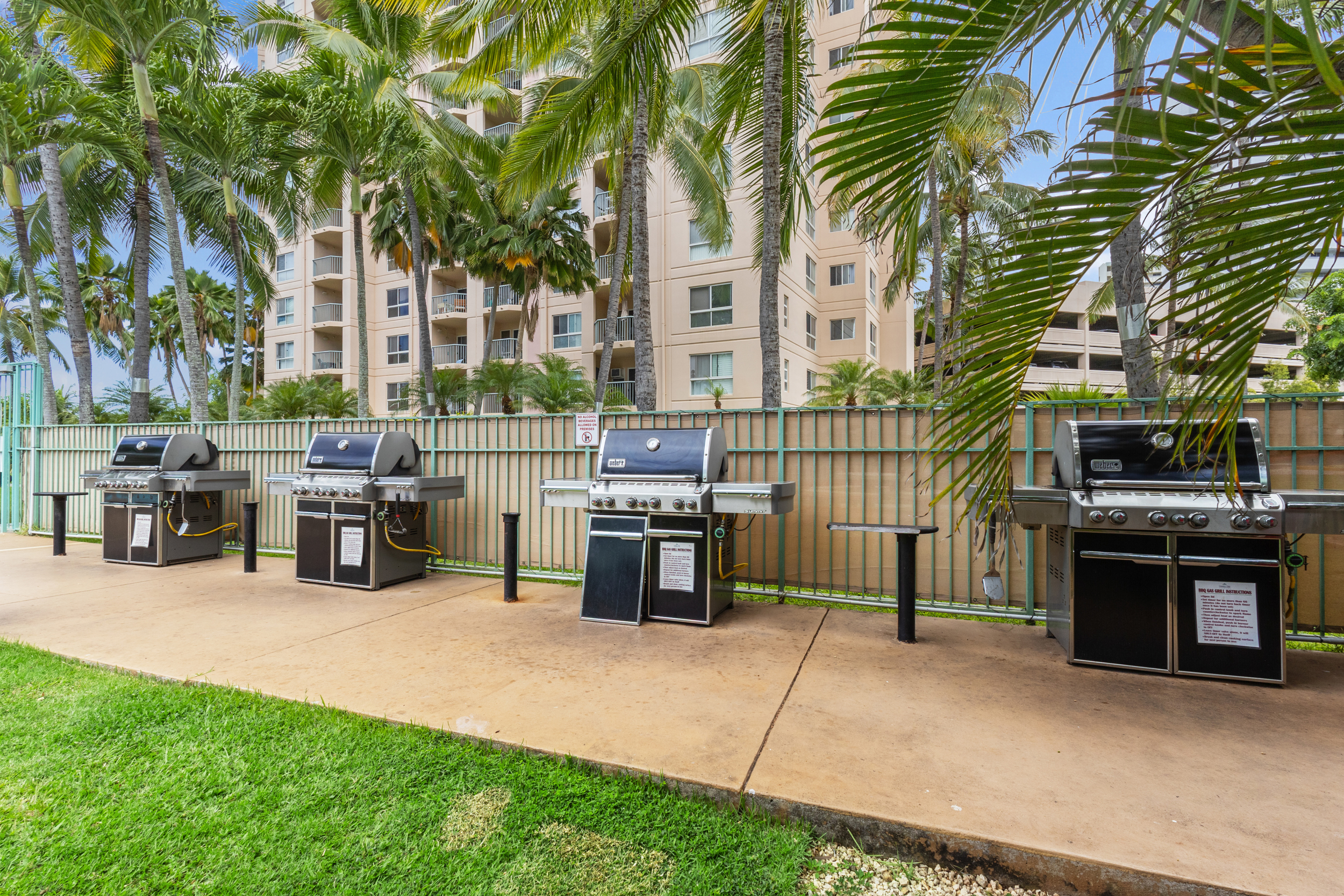 Tropical community BBQ area with multiple grills for easy outdoor dining
