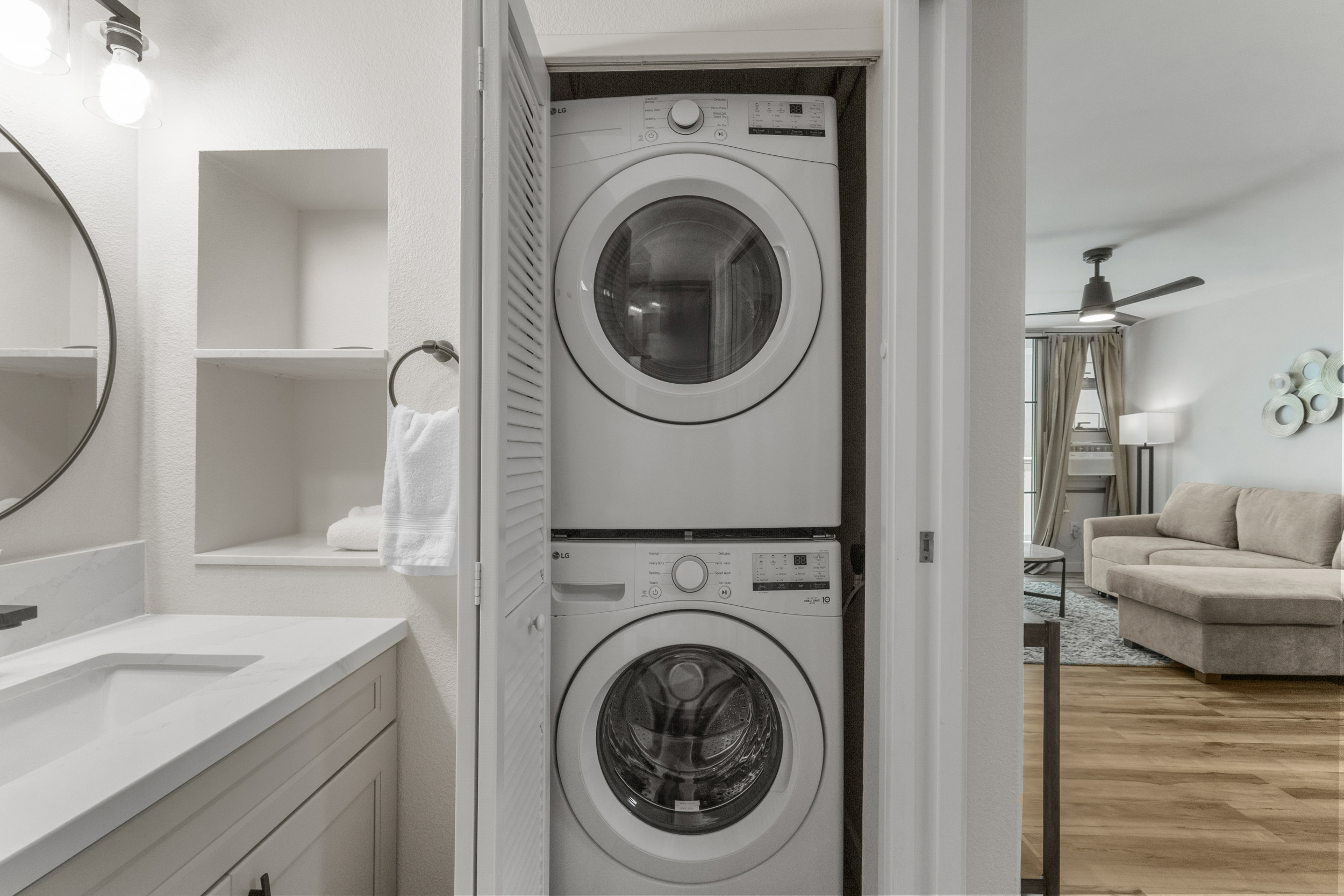 Convenient in-unit washer/dryer beside a bright, modern bath