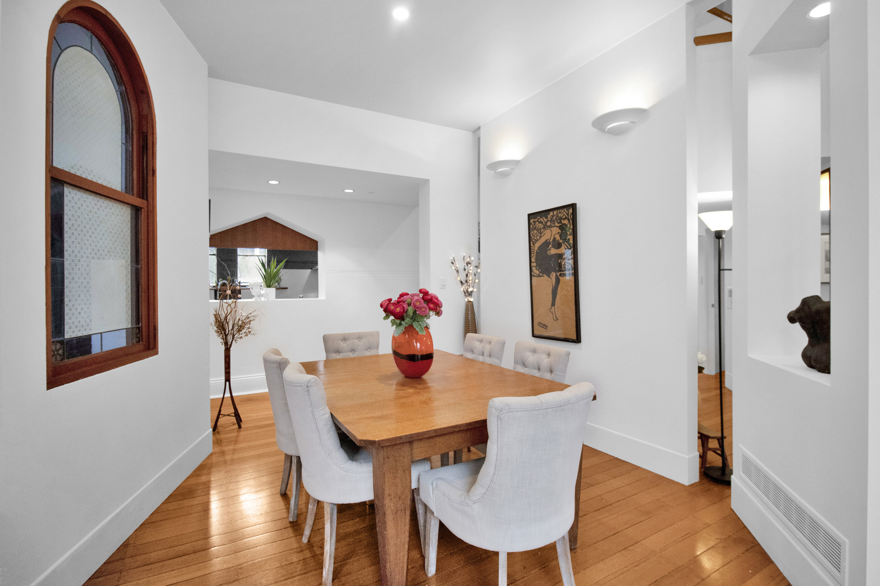 Bright dining room with hardwood floors and elegant seating for six