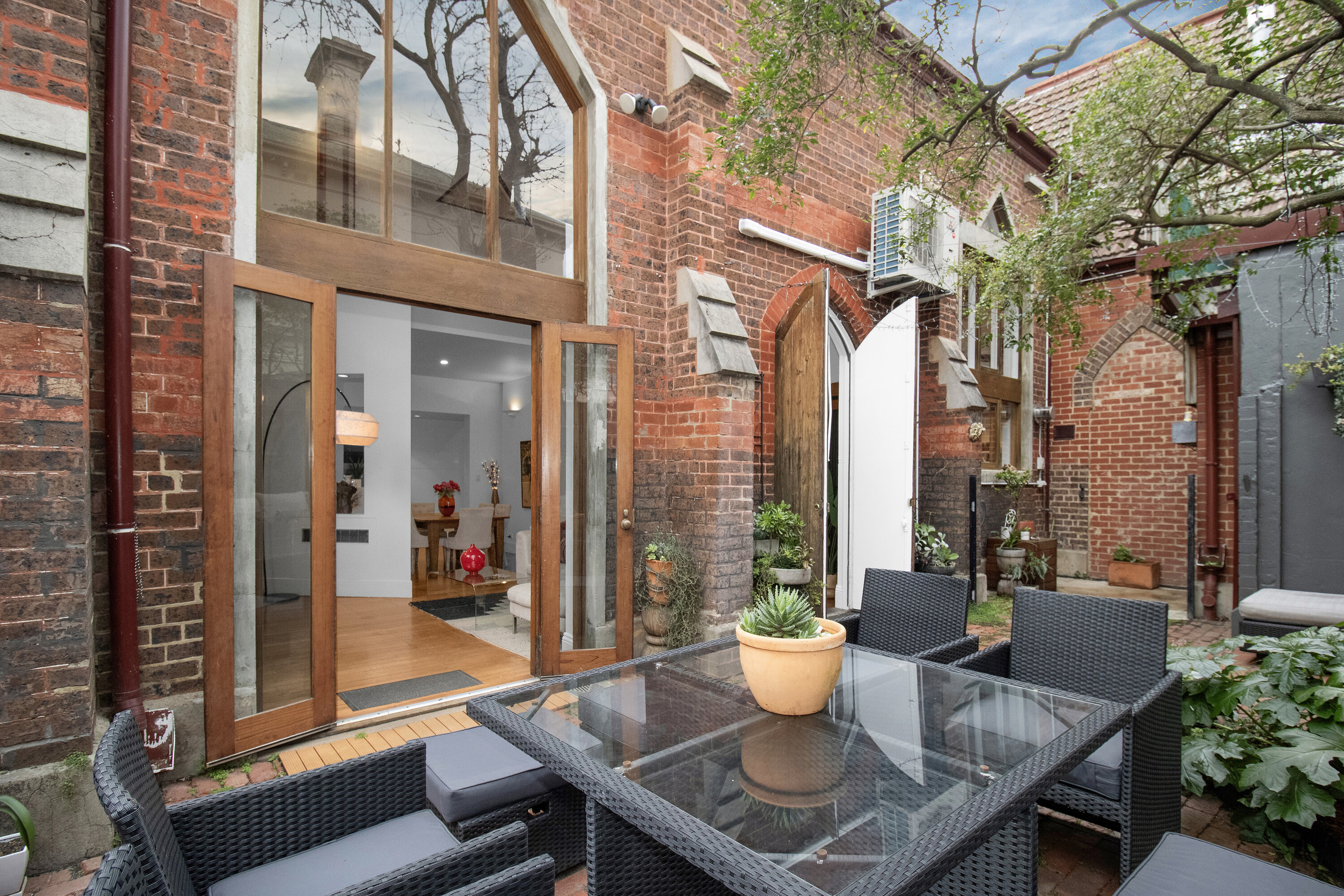 Charming brick courtyard with private patio dining and indoor-outdoor flow