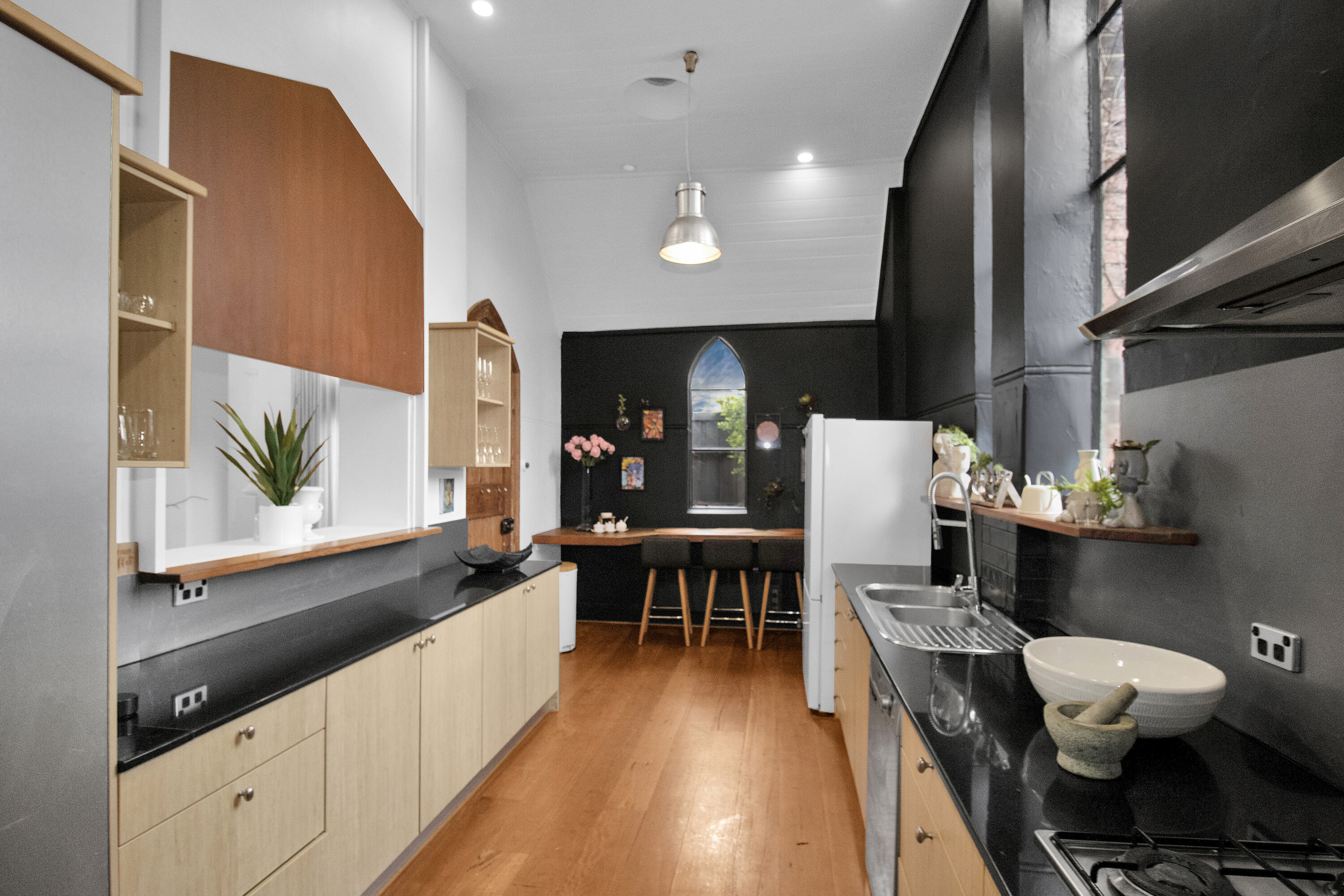 Stylish galley kitchen with breakfast bar and dramatic modern design