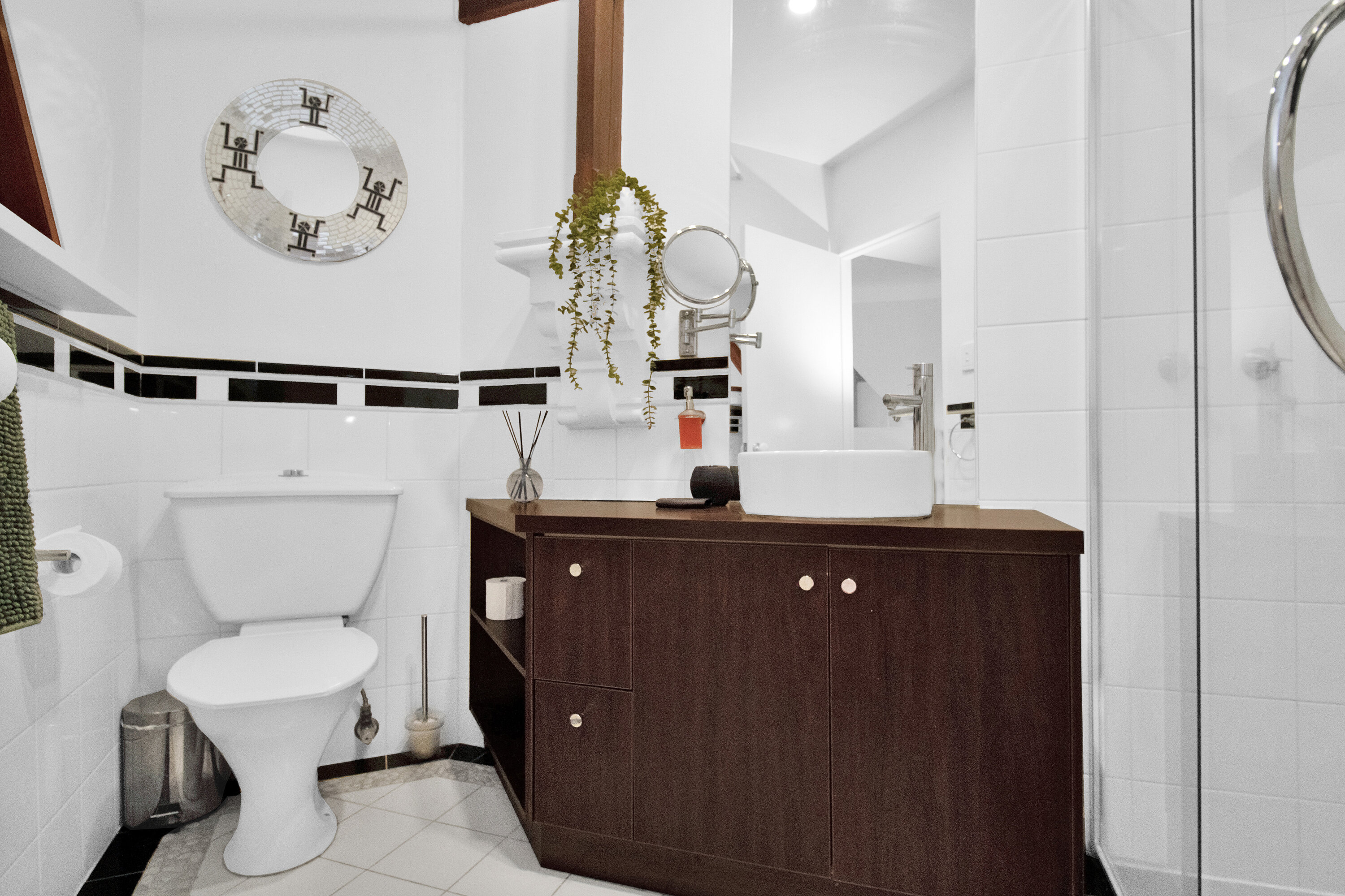 Bright modern bathroom with stylish vanity and glass shower