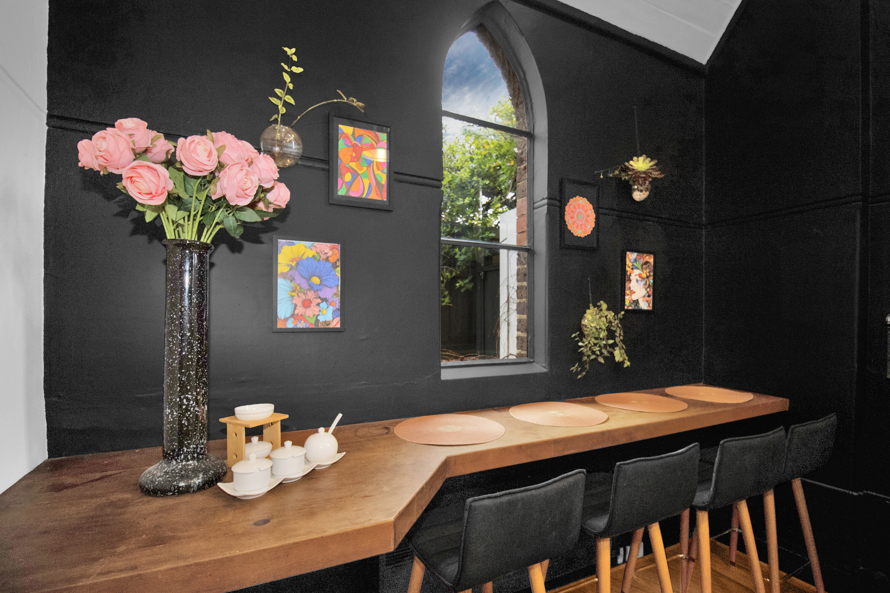 Moody modern dining nook with live-edge counter and arched window