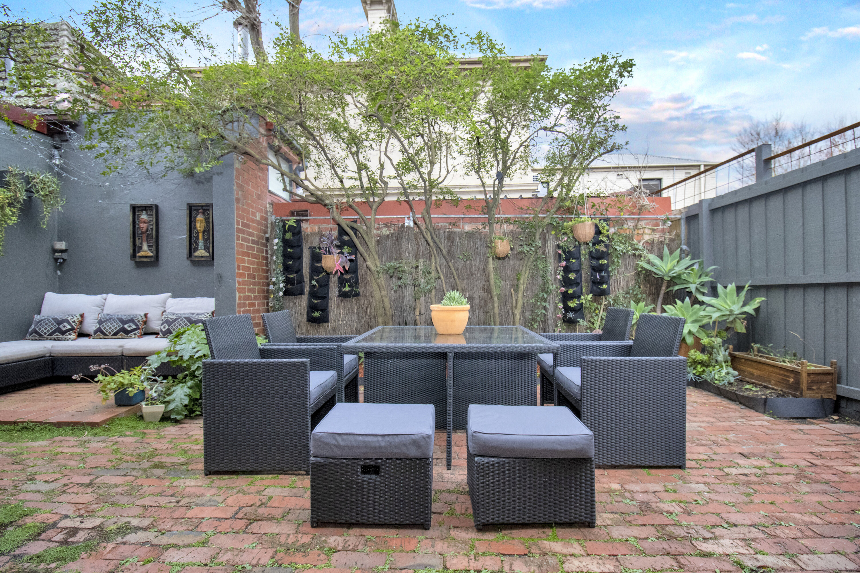 Private garden courtyard with outdoor dining and cozy lounge seating
