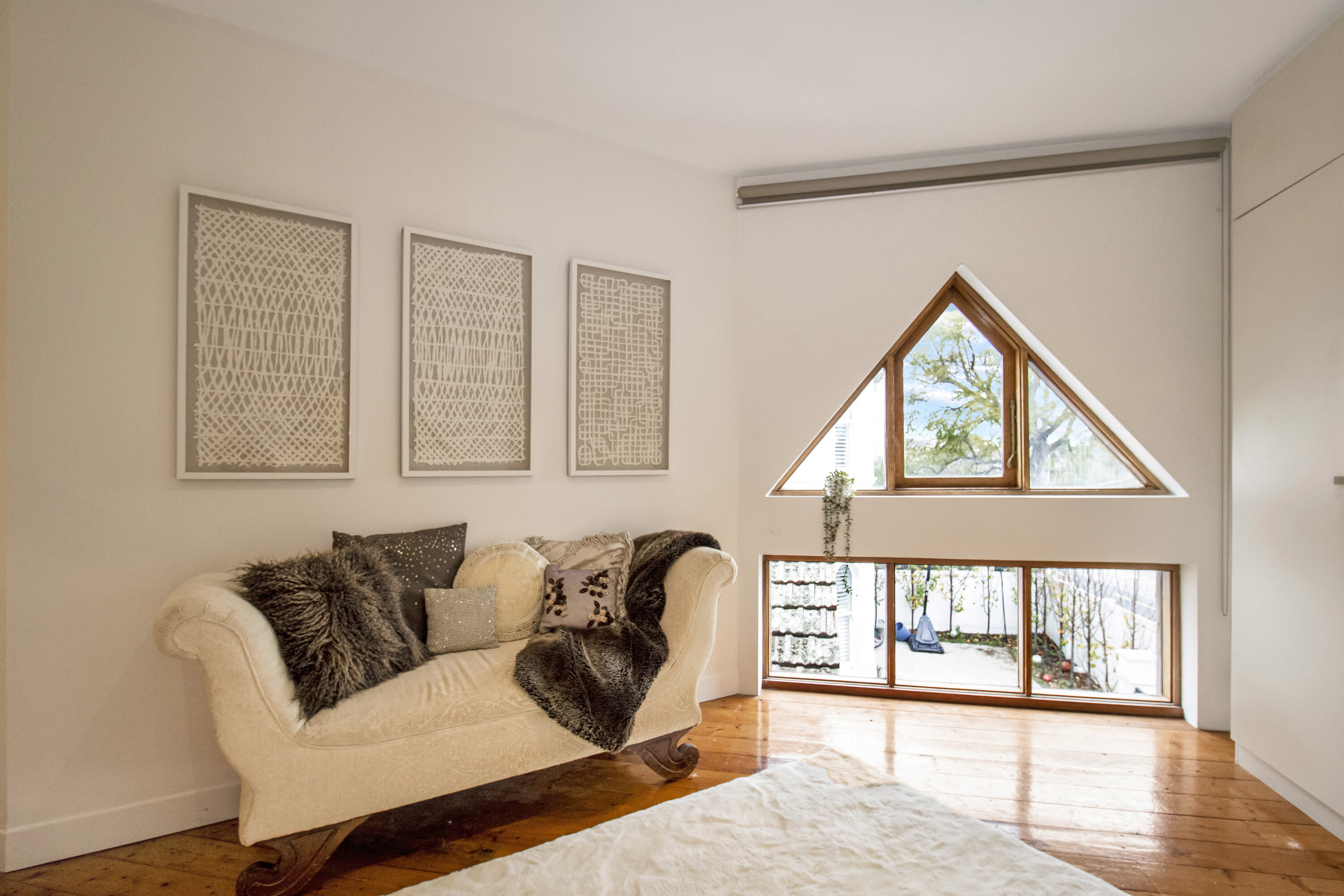 Cozy loft-style nook with statement windows and serene natural light