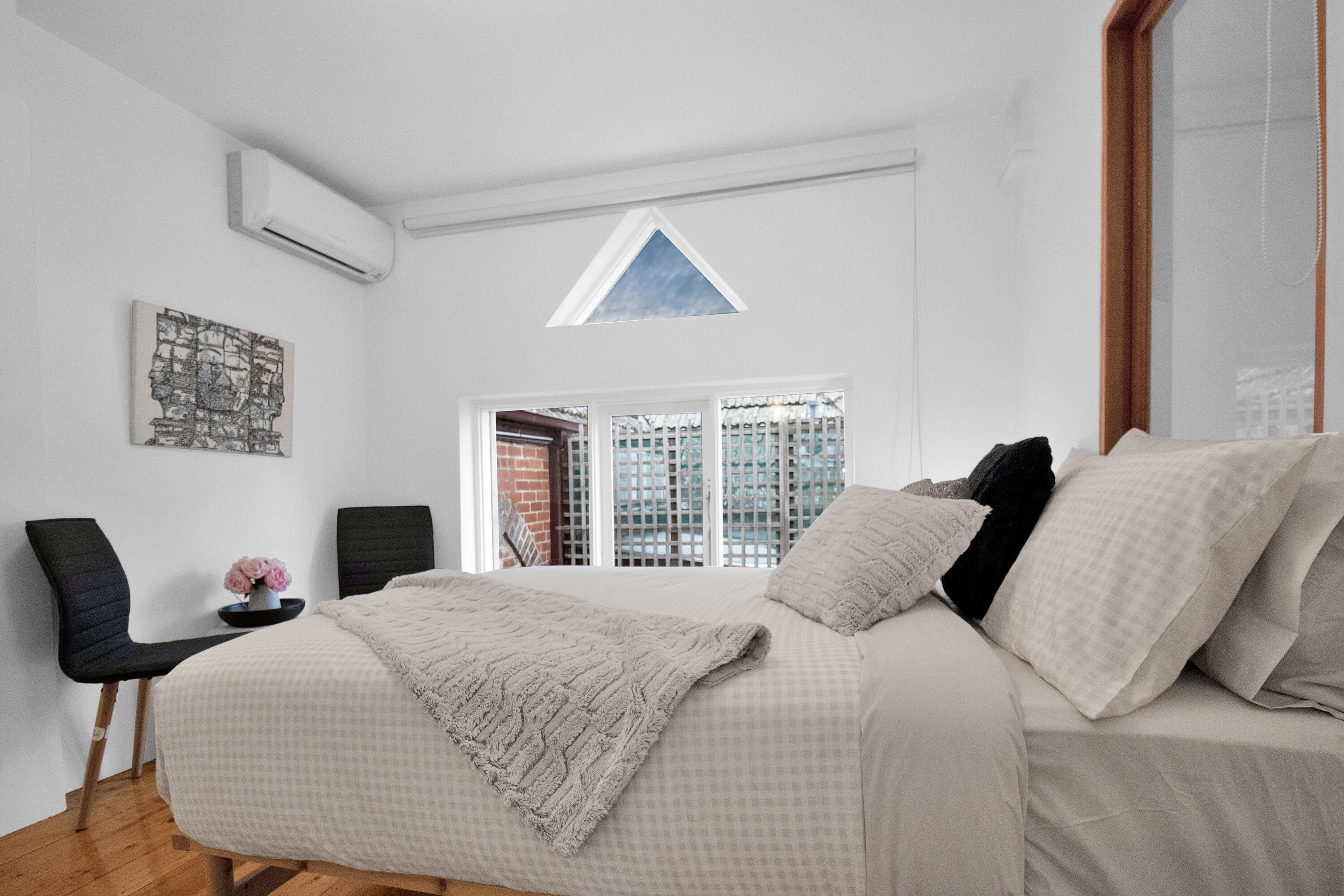 Bright, cozy bedroom with AC, plush linens, and beautiful natural light