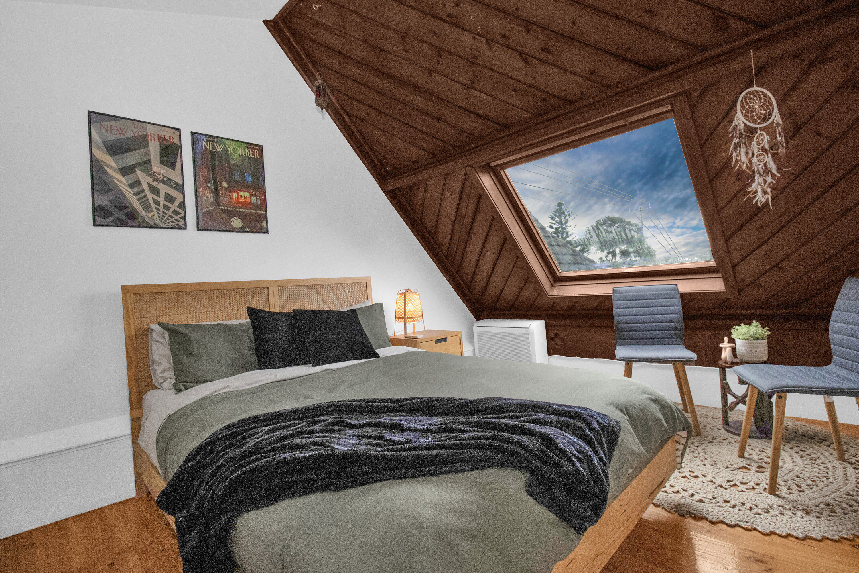 Cozy loft bedroom with skylight views and warm cabin-style charm