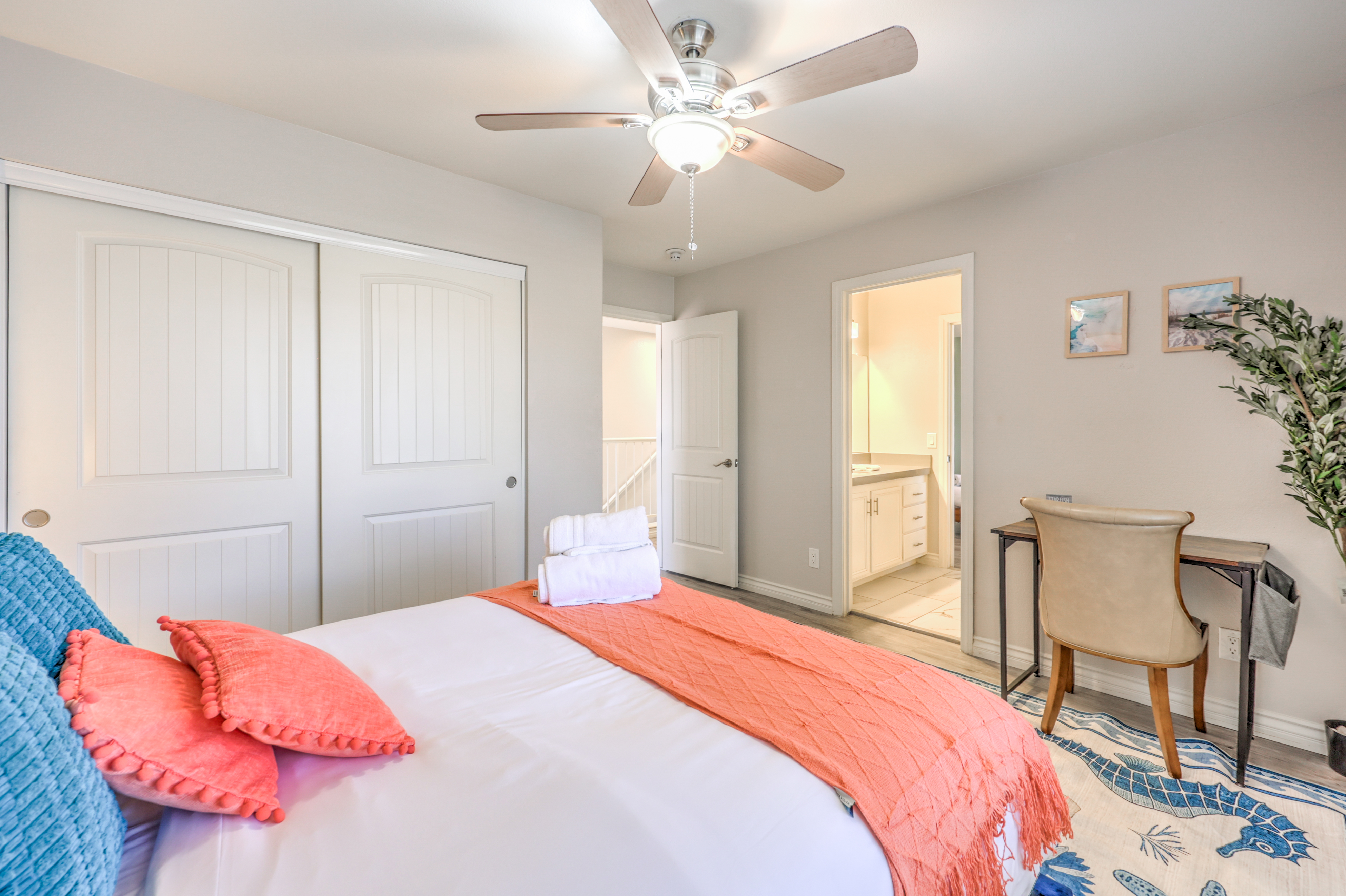 Bright bedroom with workspace, large closet, and easy bathroom access