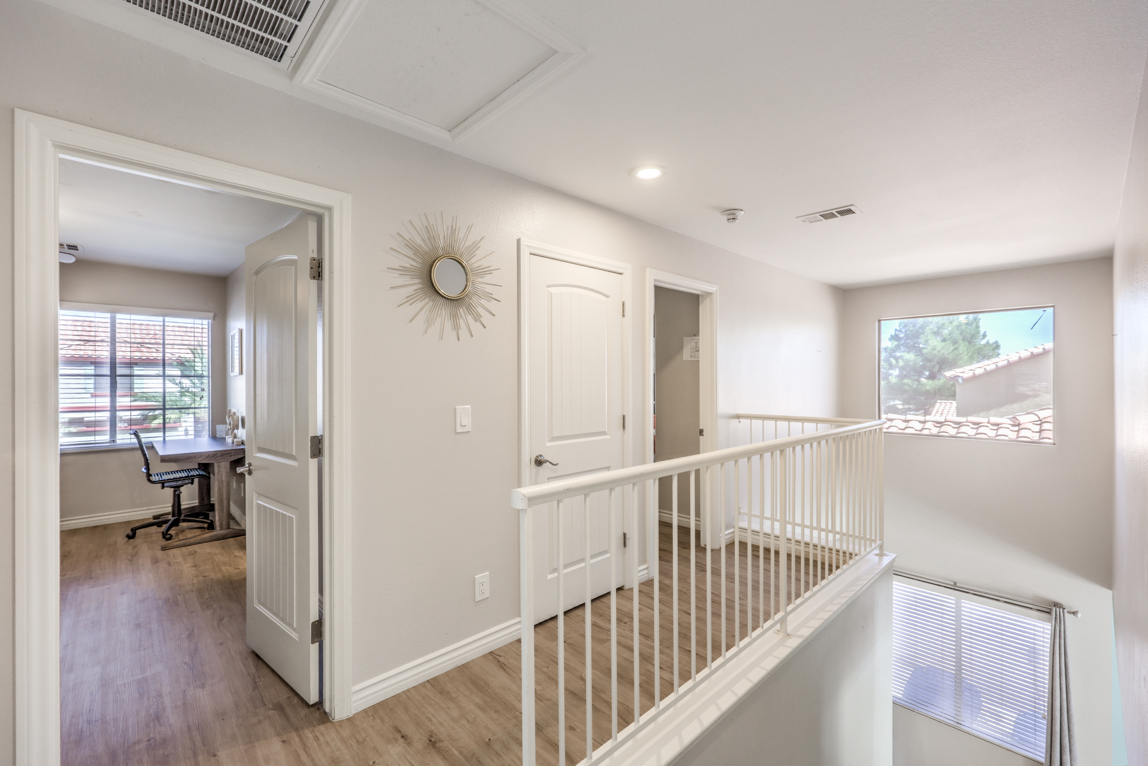 Bright upstairs landing with office access and airy natural light