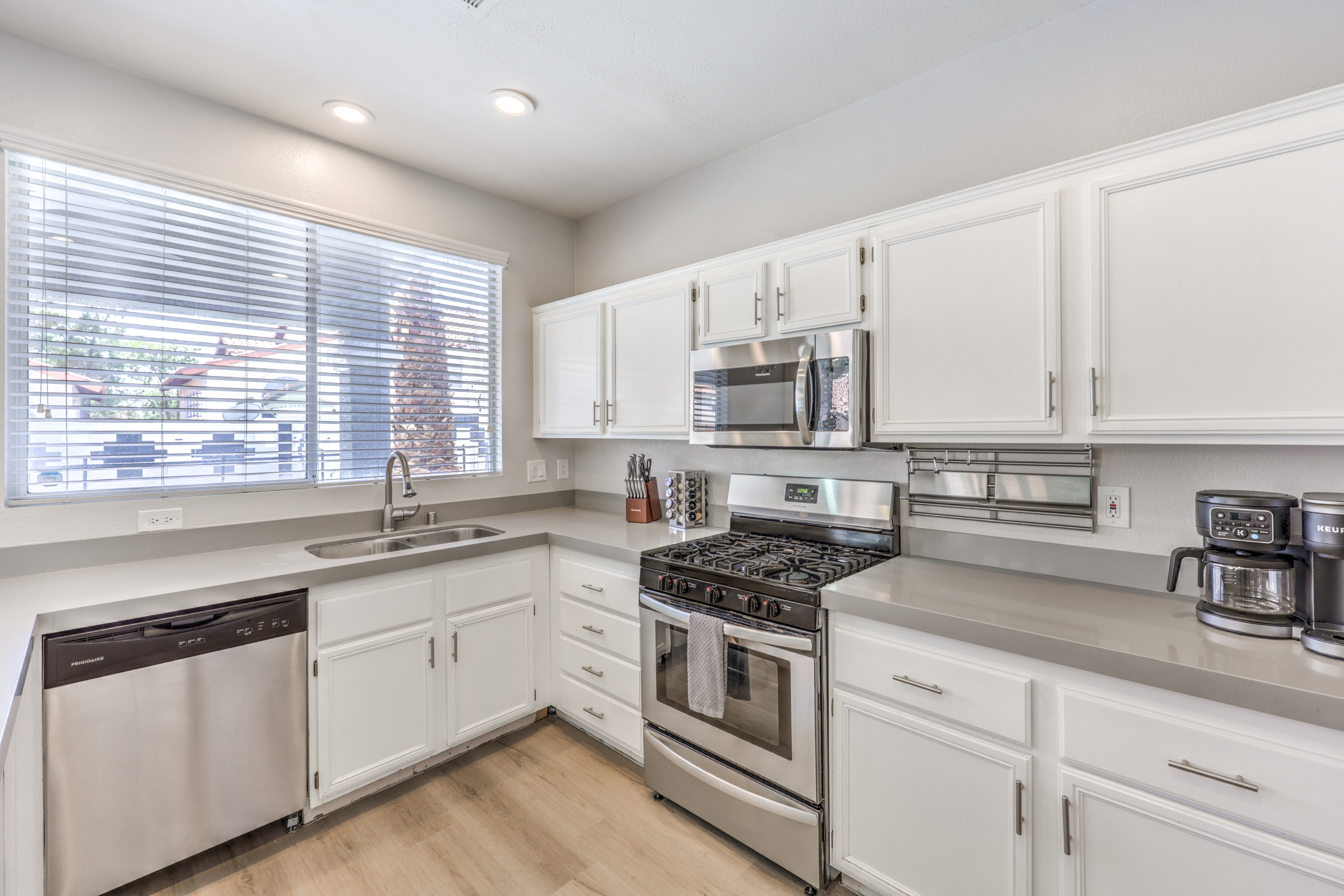 Bright modern kitchen with stainless appliances and sunny window