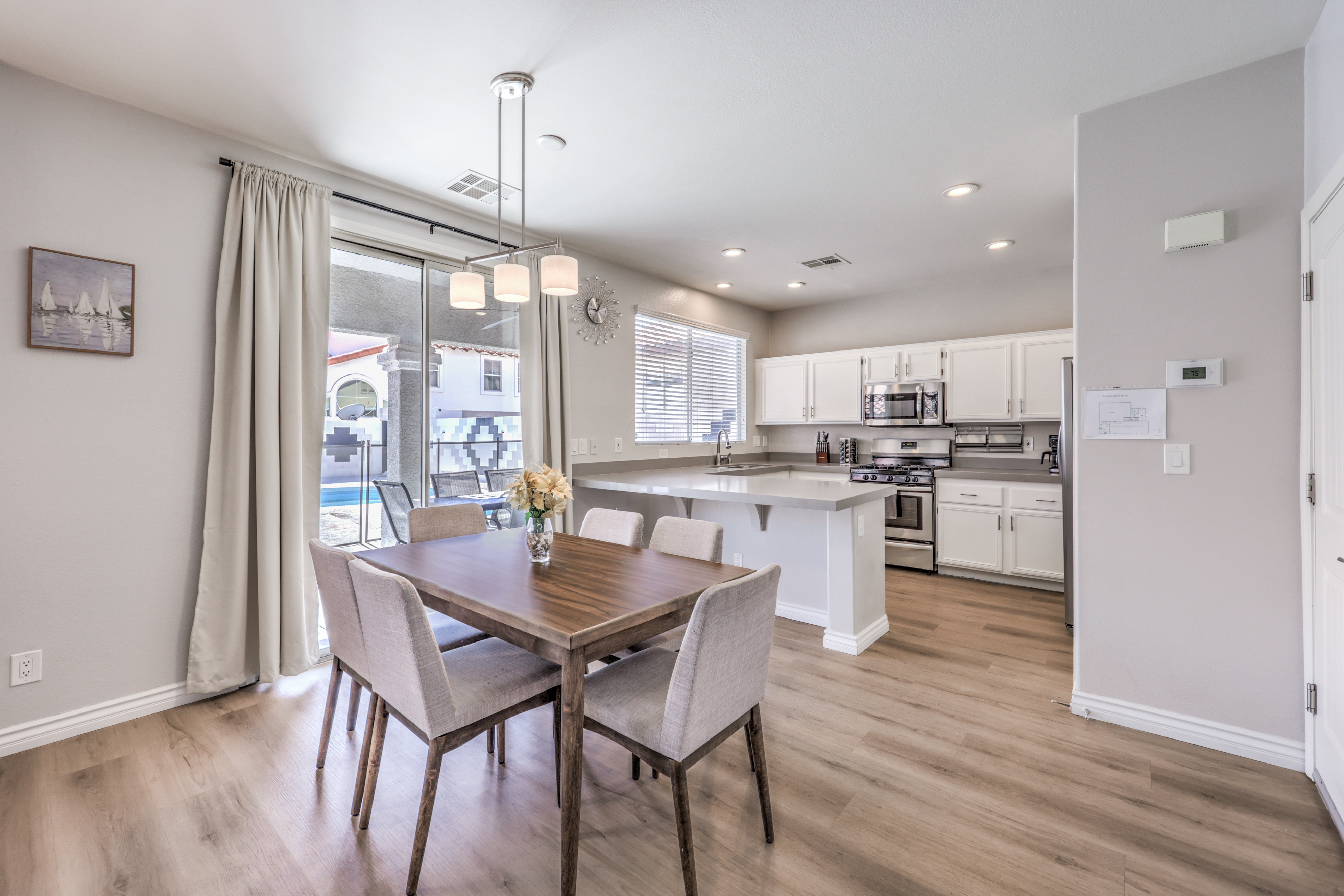Bright open dining & kitchen space with poolside patio access