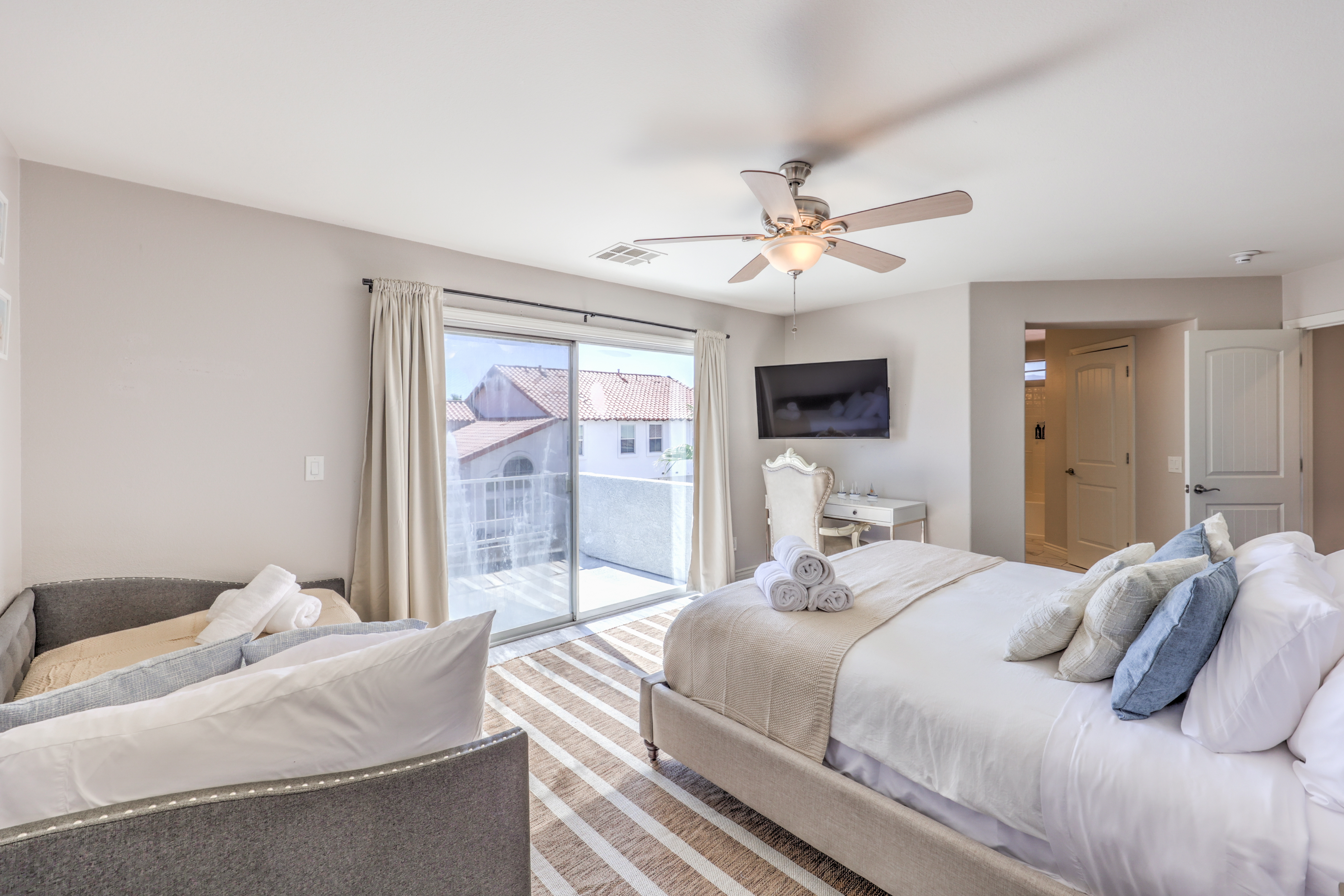 Bright king bedroom with private balcony and cozy seating area