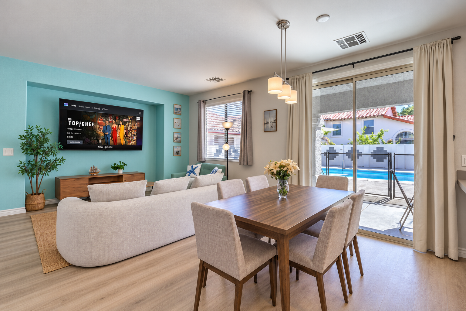 Bright open living-dining space with pool views and easy outdoor access