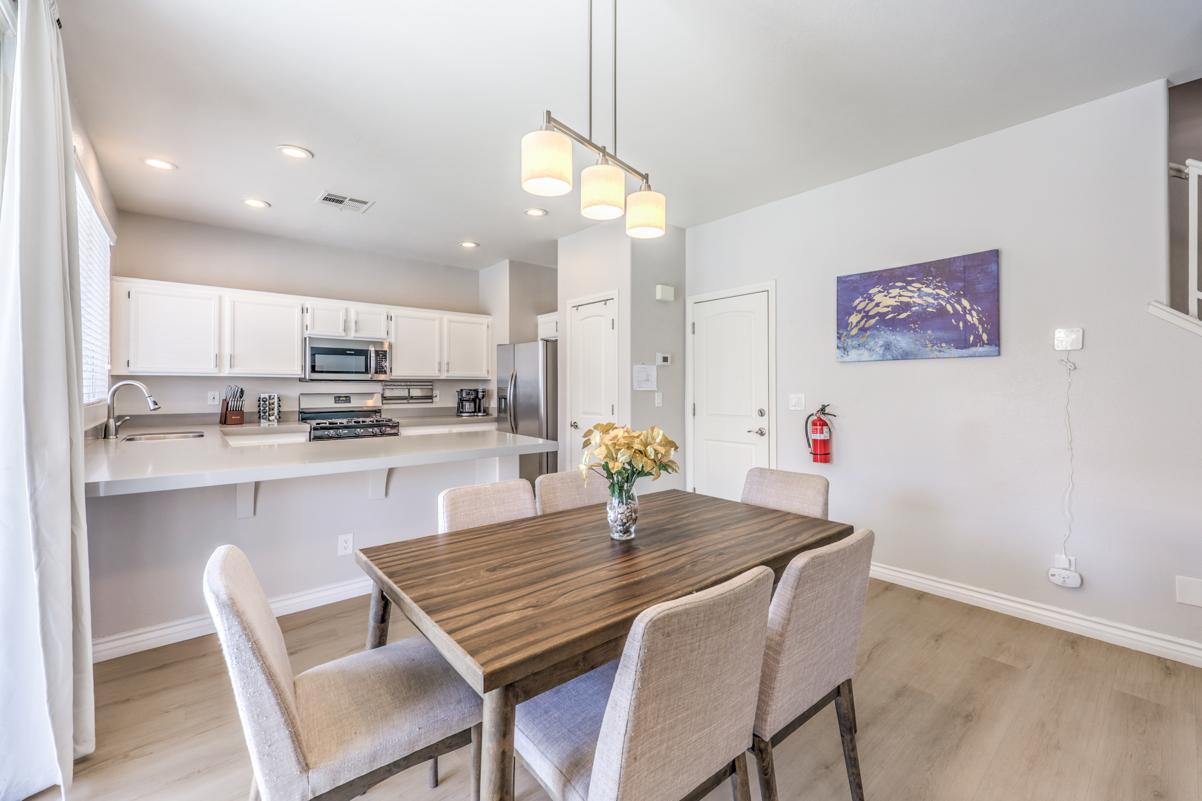 Bright open dining area with modern kitchen and seating for six