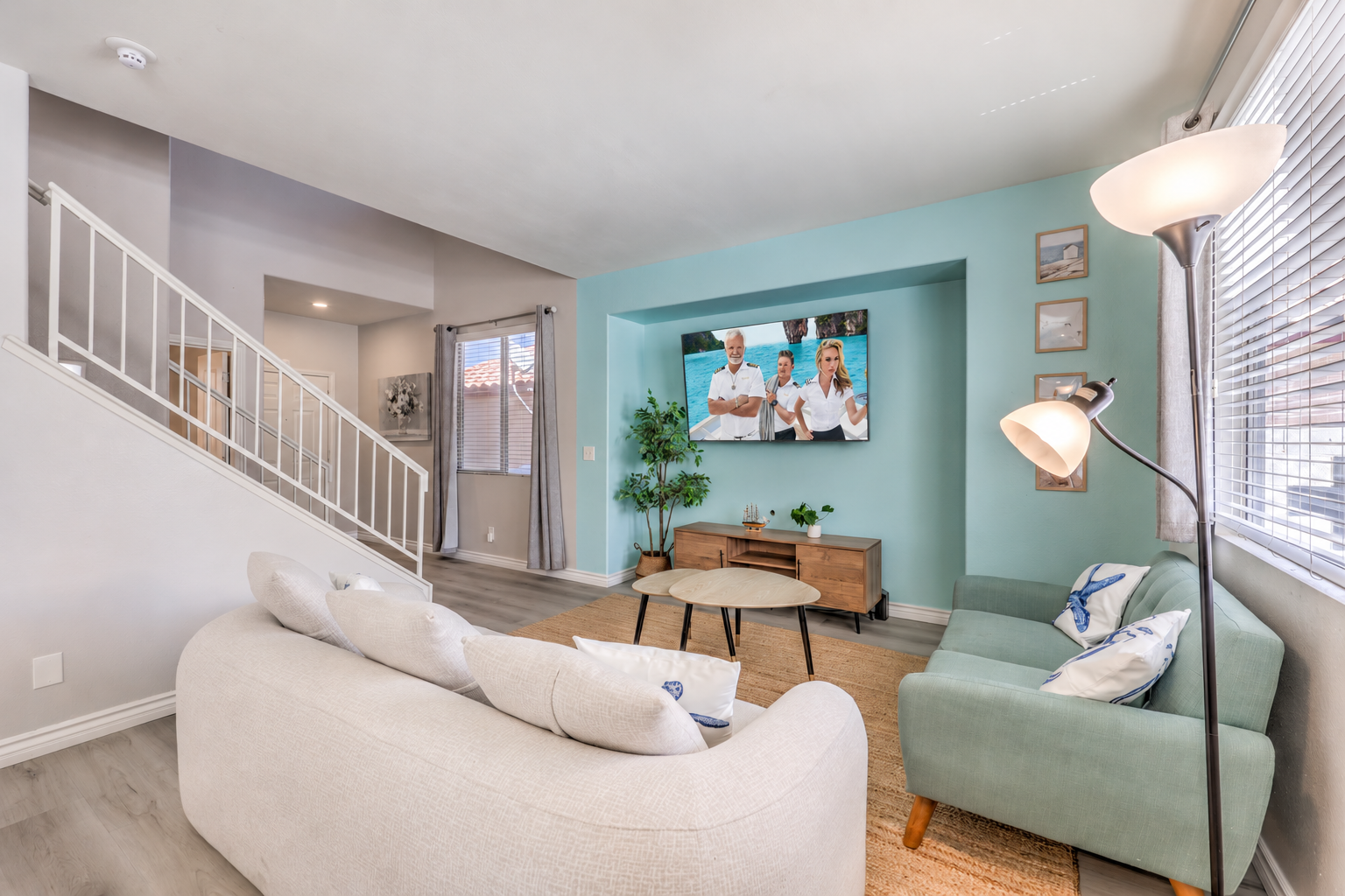 Bright modern living room with cozy seating and wall-mounted TV