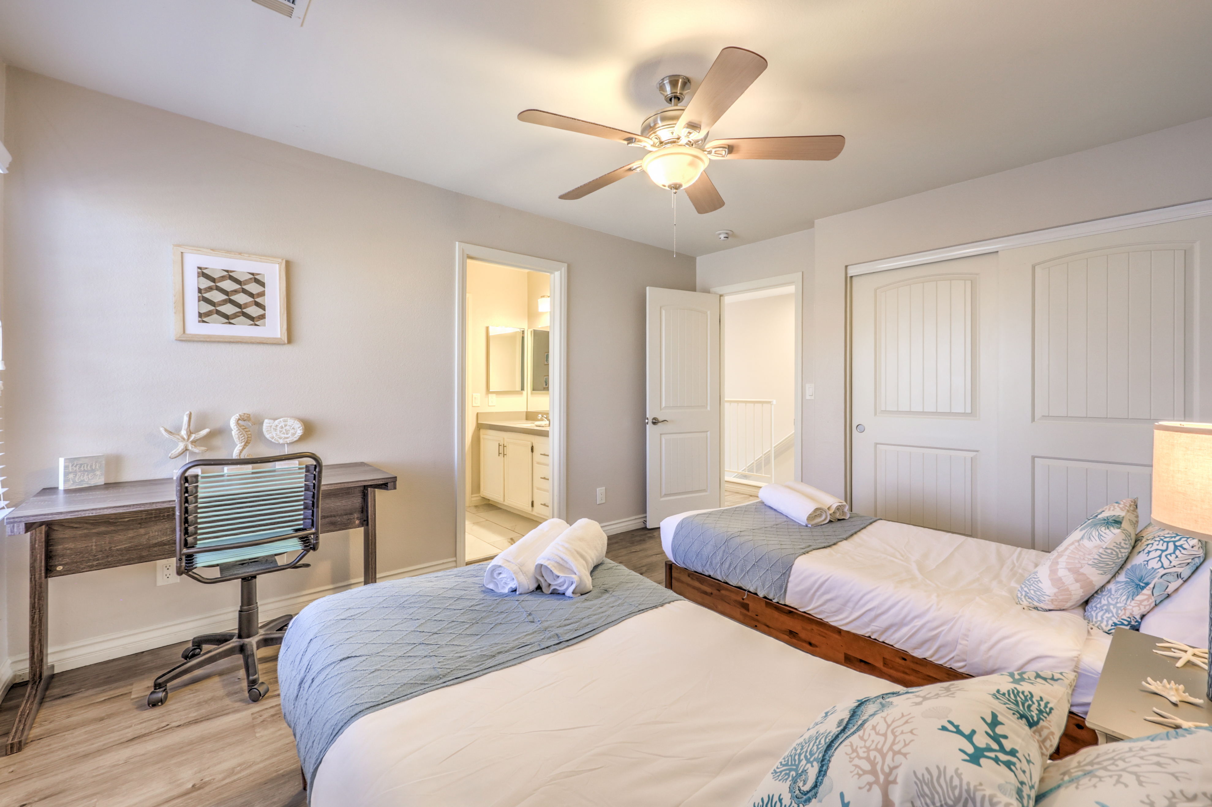 Bright twin bedroom with workspace and easy bathroom access