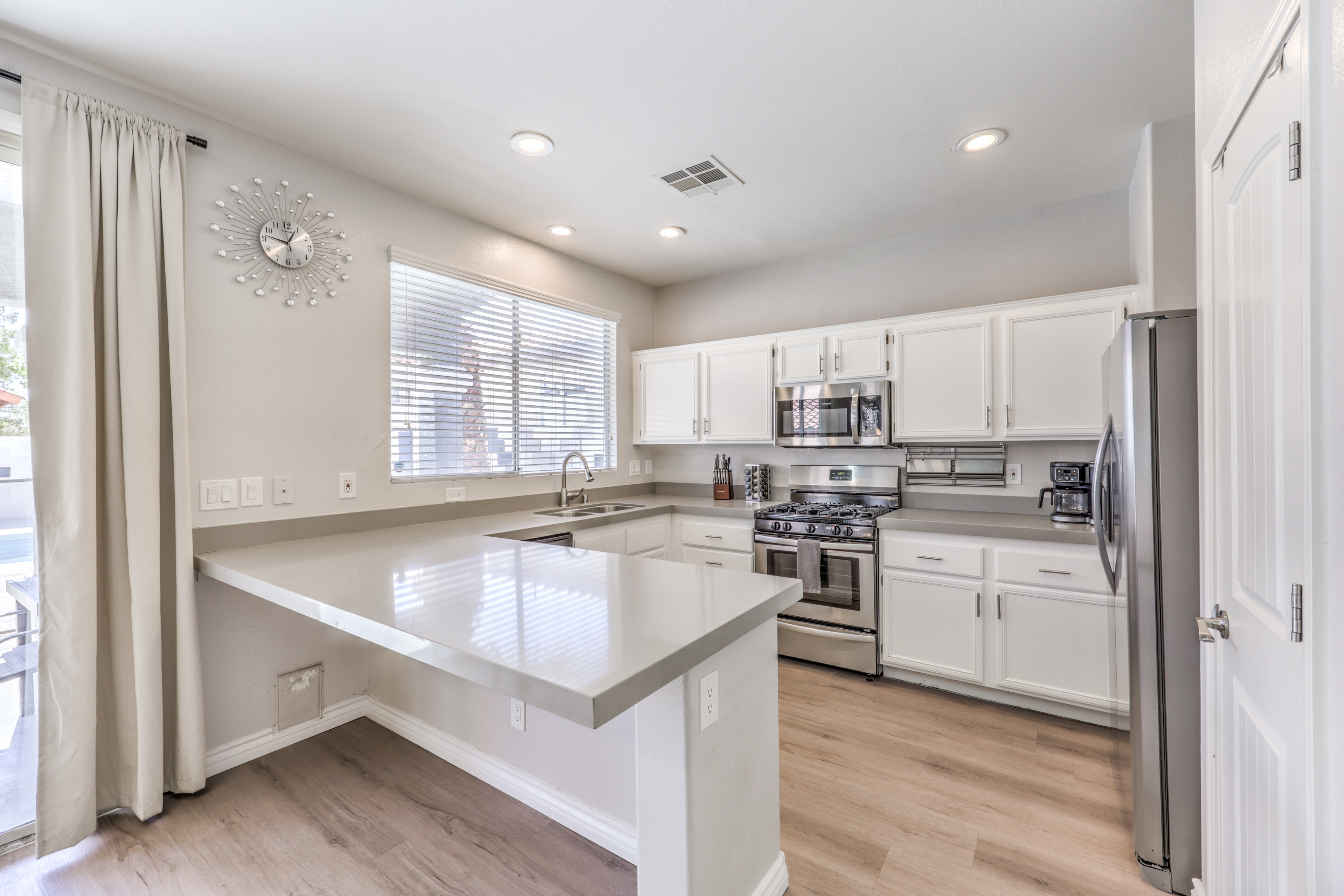 Bright modern kitchen with stainless steel appliances and spacious peninsula