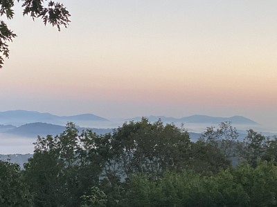 Serene mountain sunrise views with misty valleys and pastel skies