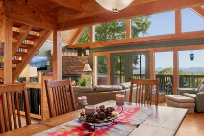 Family dinner comes with a backdrop: the dining table looks straight through the great room to the window wall and the mountains beyond. Linger over dessert, start a card game, or just watch the light change across the ridges after the meal.