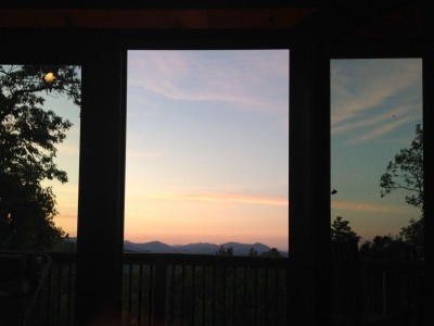 Sunset mountain views from the private deck and floor-to-ceiling doors