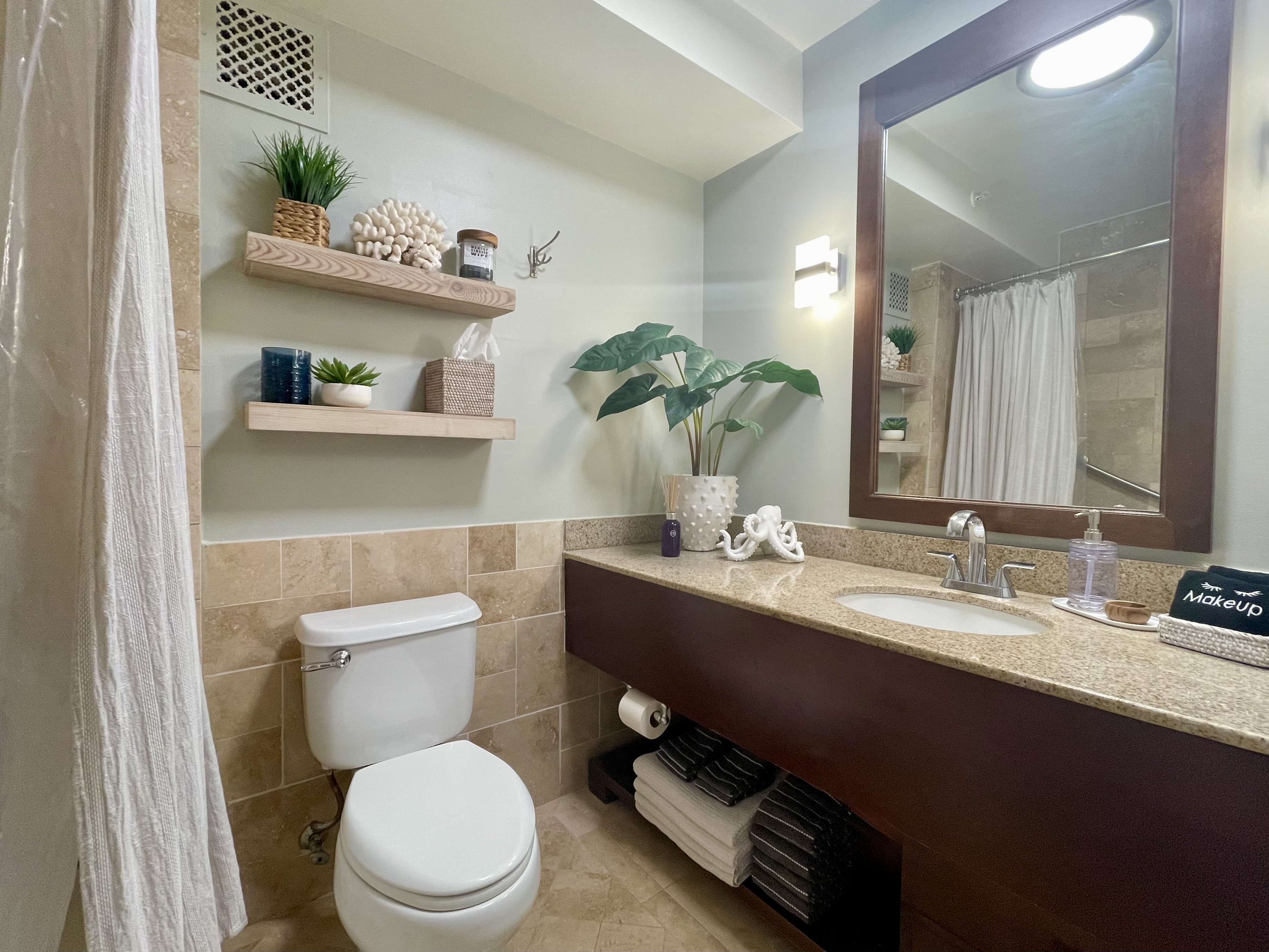 Stylish bathroom with granite vanity, warm finishes, and spa-like touches