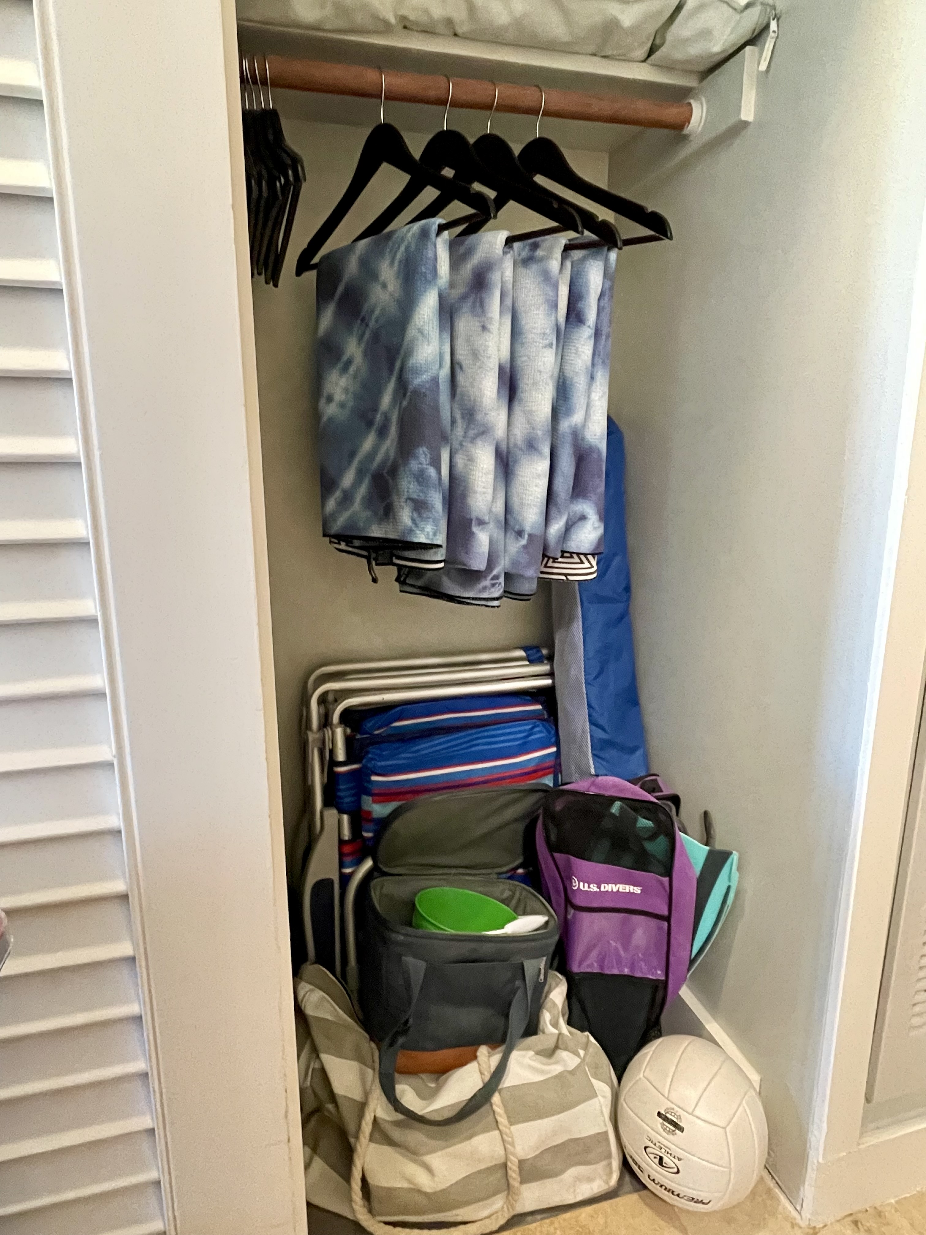 Beach gear closet with chairs, cooler, totes, umbrella, snorkel gear, and guest storage