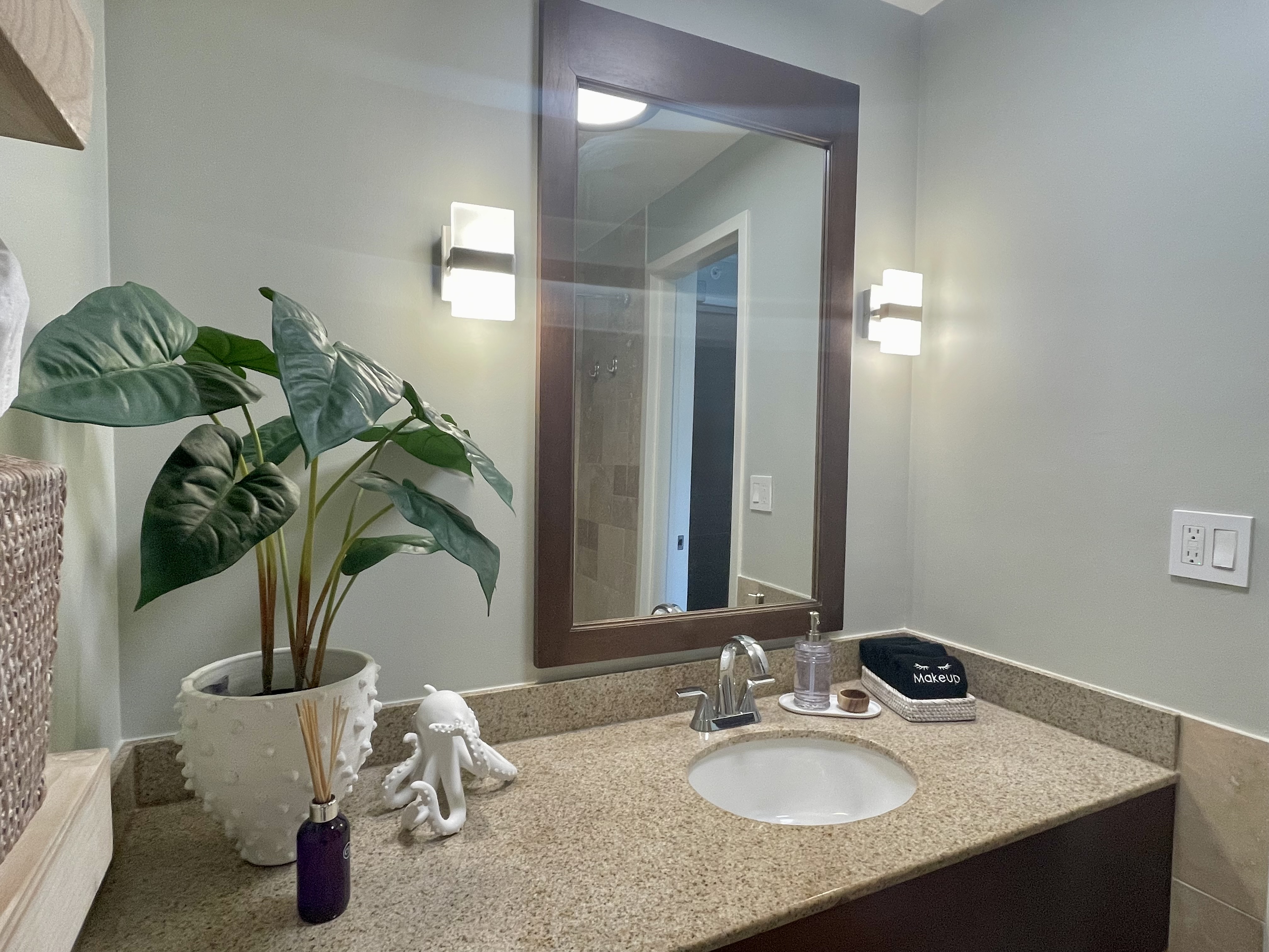 Bright vanity with granite counters and spa-like modern touches