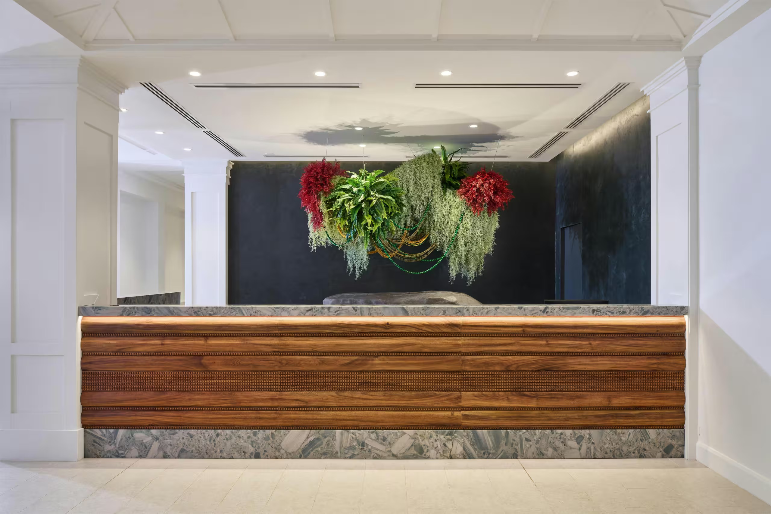 Boutique-style lobby with designer greenery and sleek reception desk