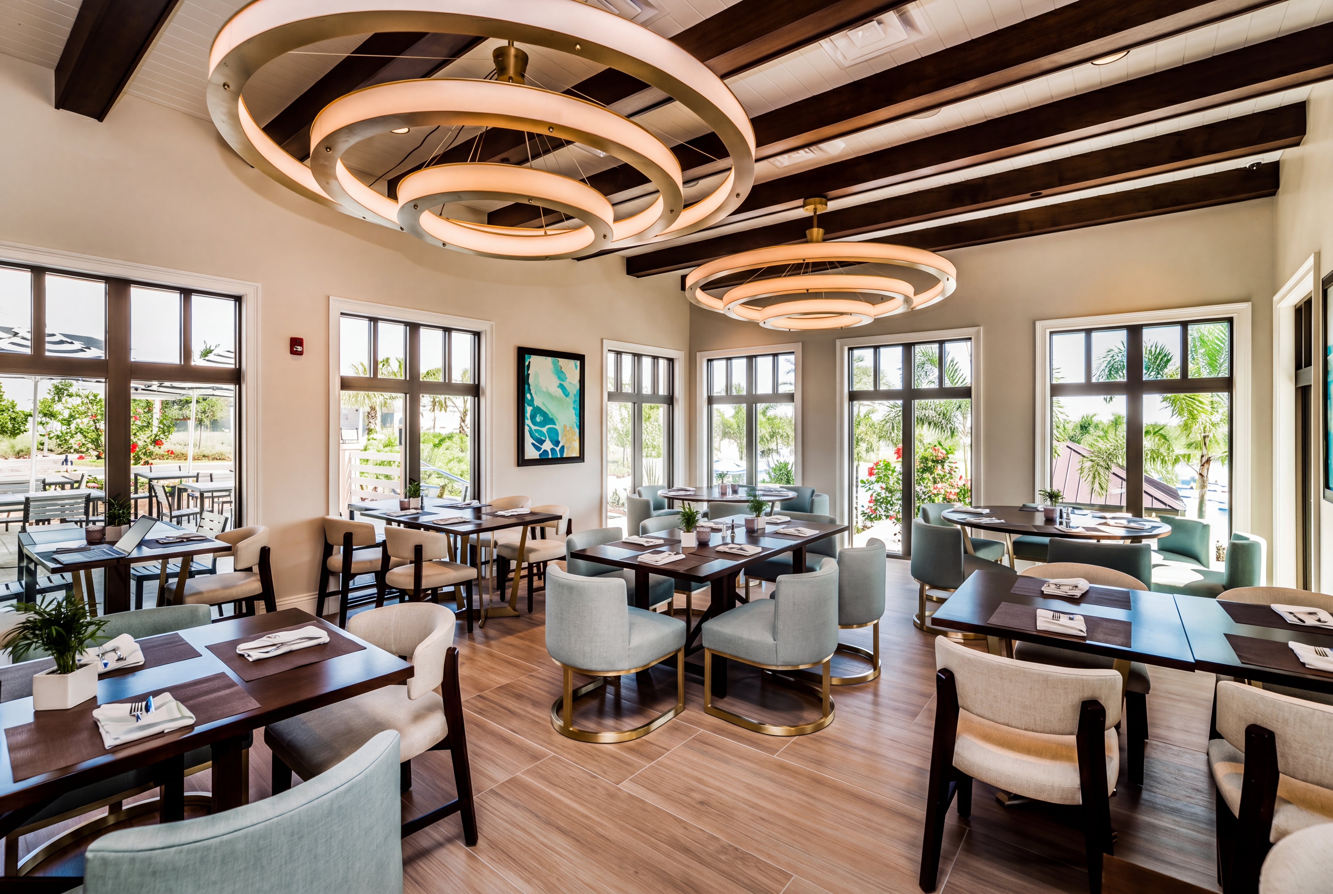 Bright, elegant dining space with designer lighting and tropical views