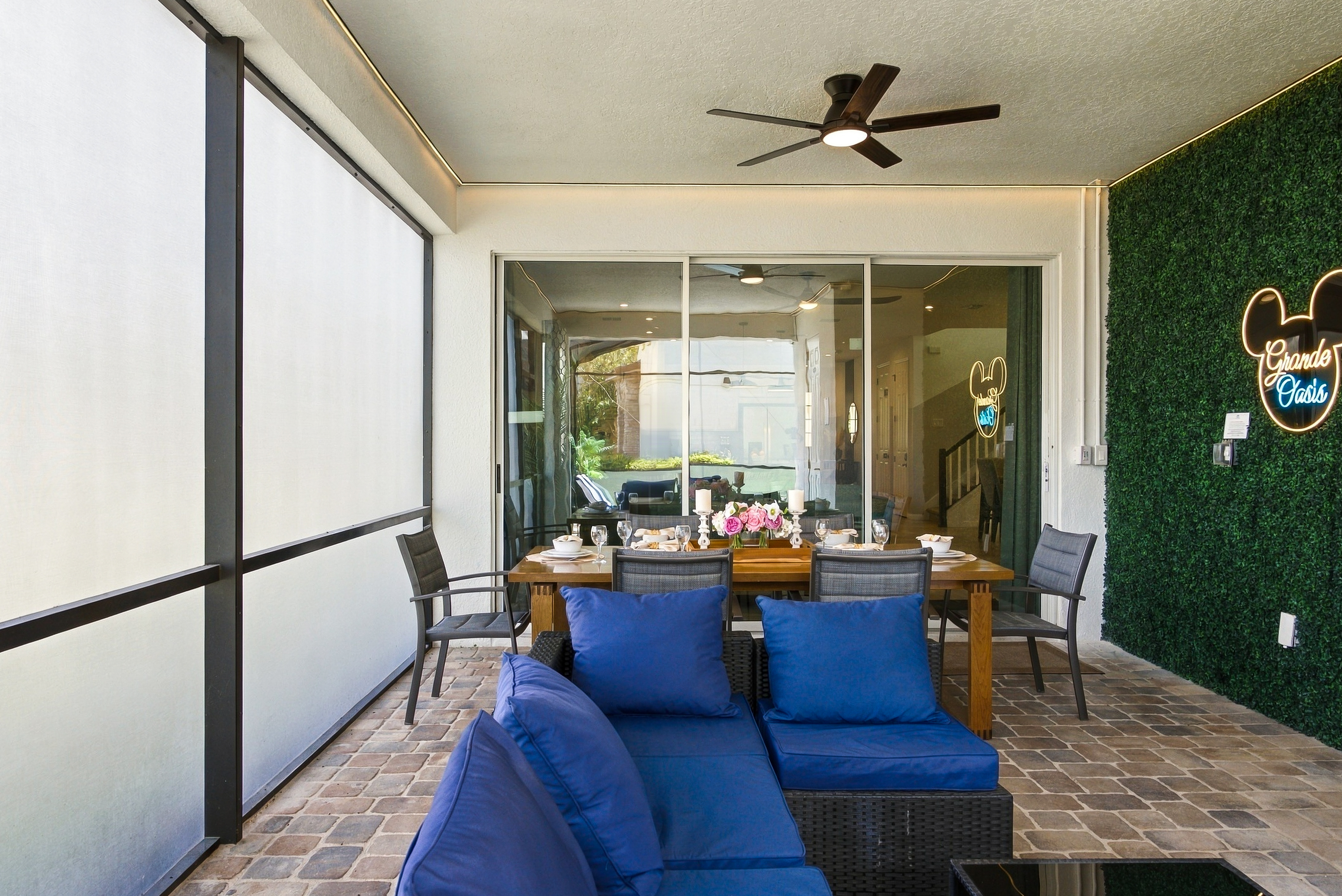 Covered patio with lounge seating, dining area, and stylish privacy