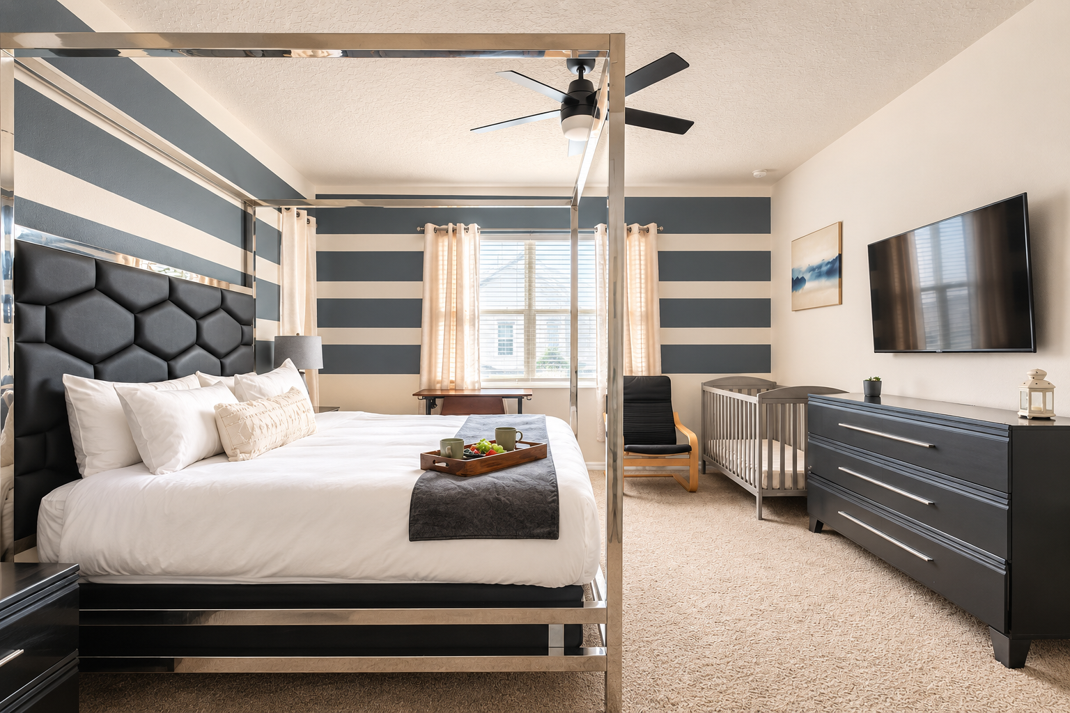 Stylish king bedroom with TV, crib, and bold designer touches