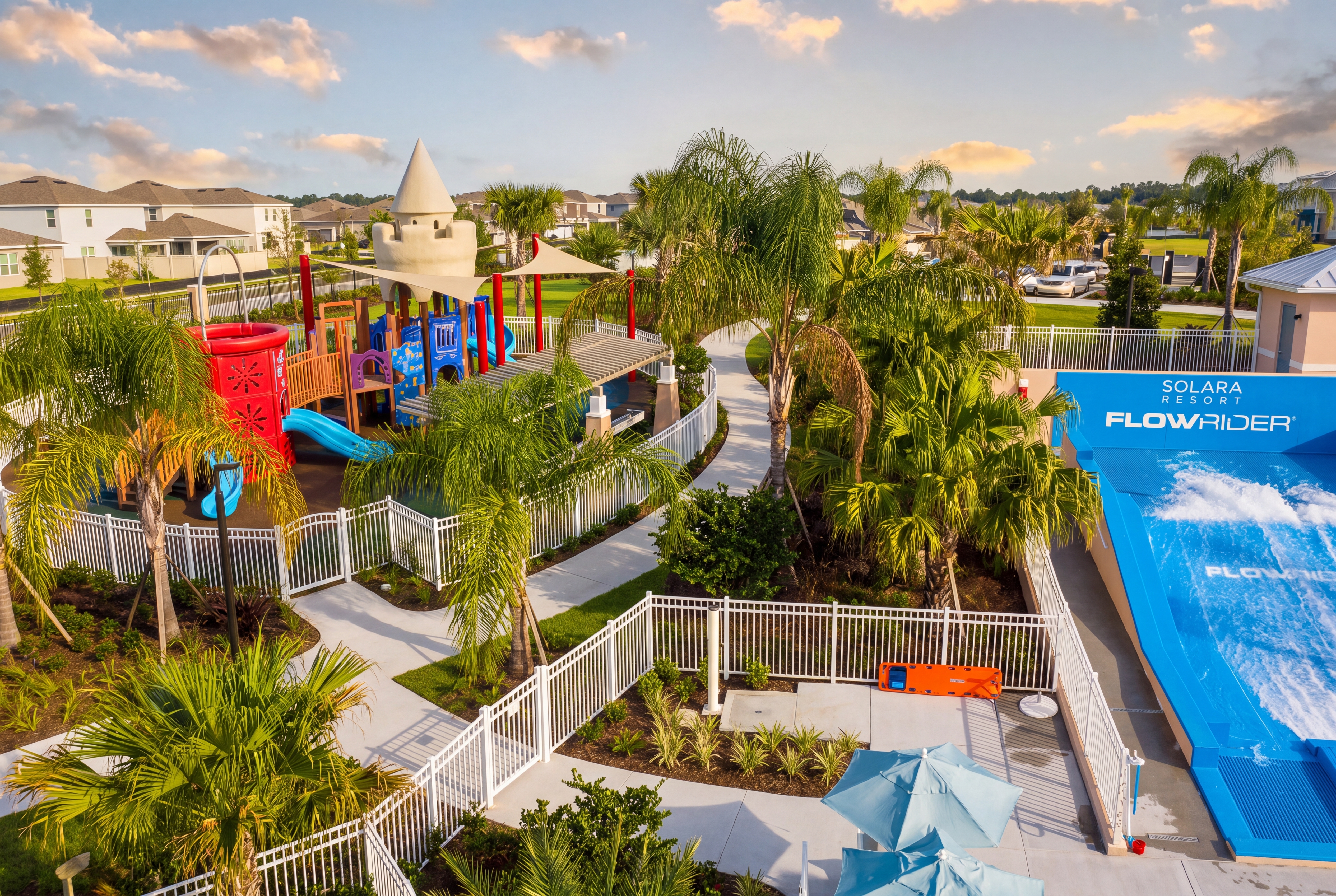 Resort-style fun with playground, palms, and exciting FlowRider surf simulator