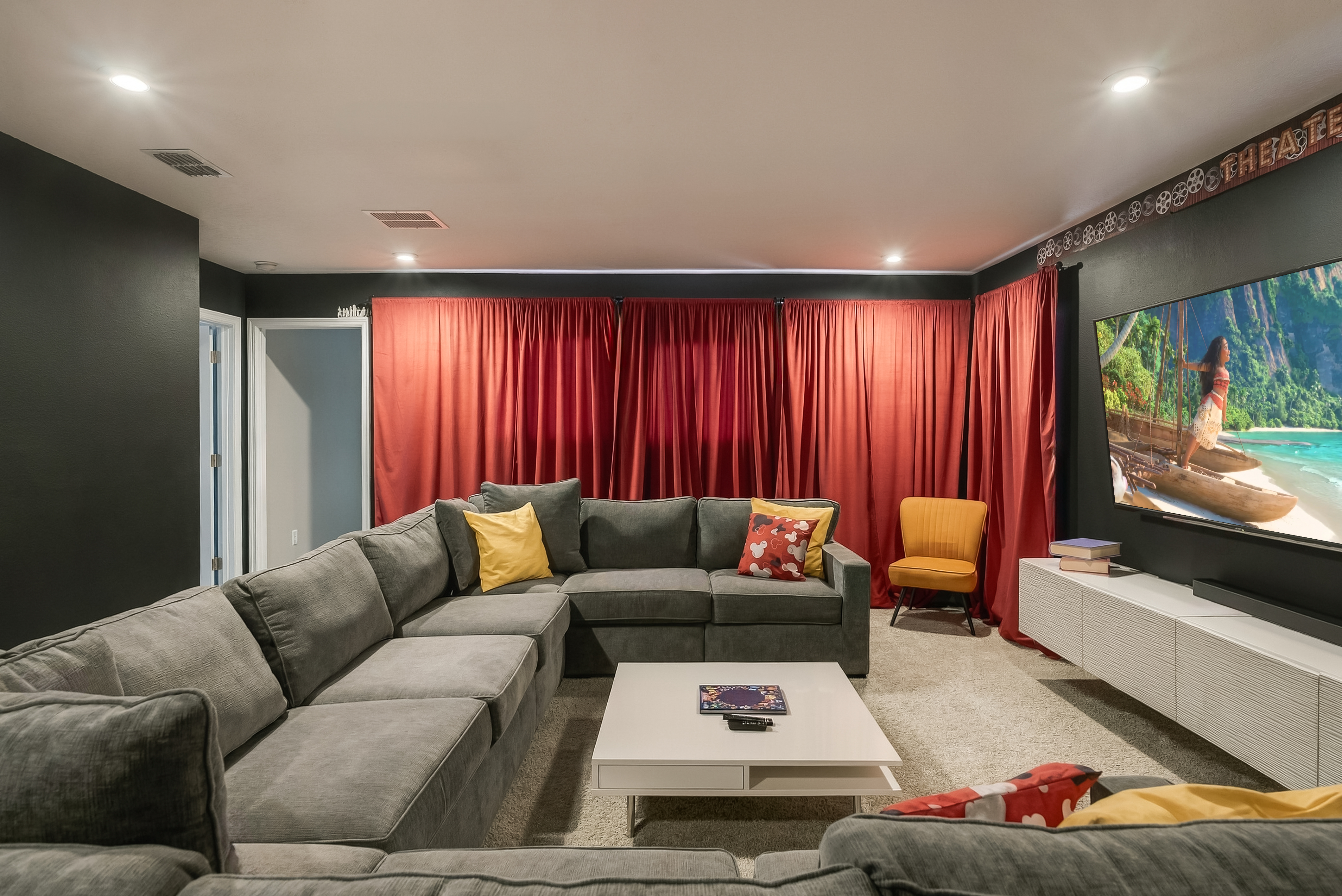Cozy home theater with oversized sectional and cinematic blackout curtains